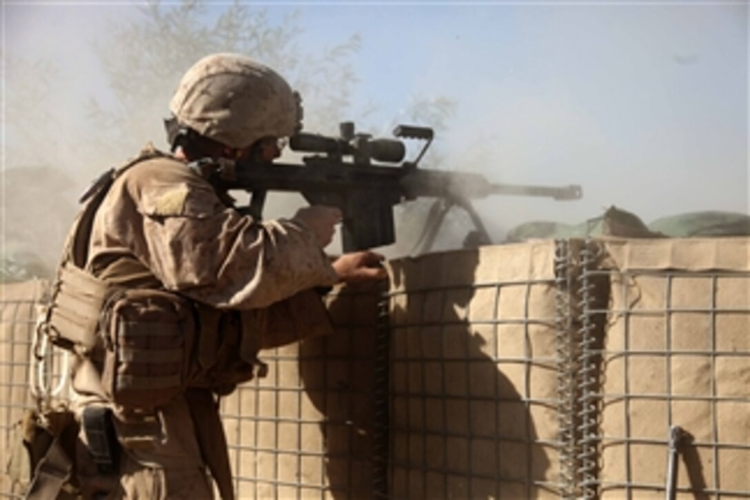 U.S. Marine Corps Sgt. Corey Sherwood provides cover fire for Marines assigned to an explosive ordnance disposal unit in Sangin, Afghanistan, on Nov. 9, 2010.  The unit was performing a post-blast assessment when it was attacked by insurgents.  Sherwood is assigned to Lima Company, 3rd Battalion, 5th Marine Regiment, Regimental Combat Team 2, whose mission is to conduct counterinsurgency operations in partnership with the International Security Assistance Force.  
