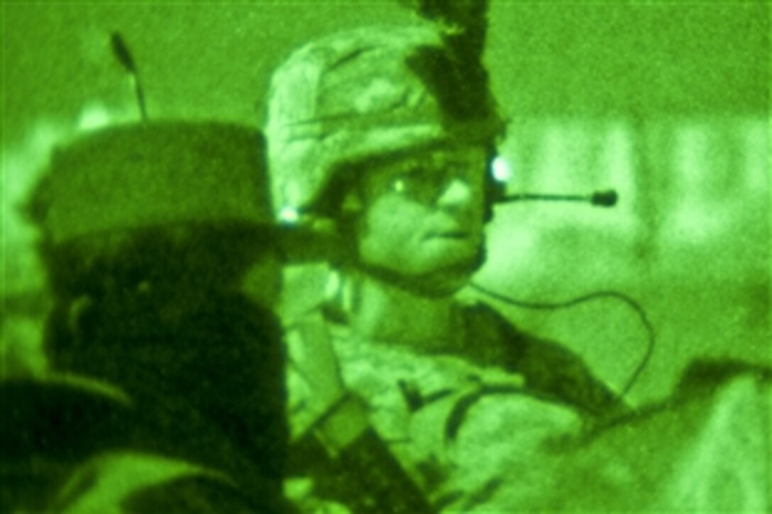 As seen through a night-vision device, U.S. Army 2nd Lt. George Kane briefs Afghan police officers before departing on Operation Gazme Shab 3 on Forward Operating Base Rushmore, Afghanistan, Nov. 18, 2010. The purpose for the operation is to assess local activity in the evening hours and gather intel for future operations. 