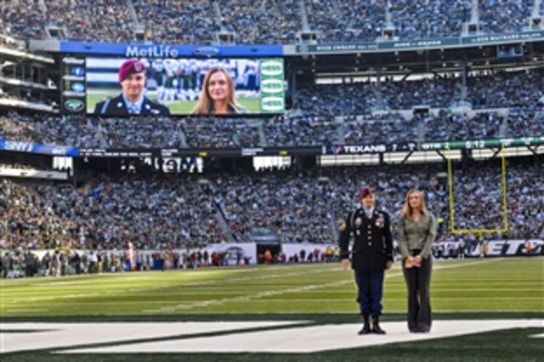 Medal of Honor recipient U.S. Army Staff Sgt. Salvatore Giunta and his wife, Jennifer, stand as the audience applauds at  Meadowlands Stadium in East Rutherford, N.J., Nov. 21, 2010. Giunta, who received recognition as part of the New York Jets Military Appreciation Day, is the award's first living recipient since the Vietnam War.