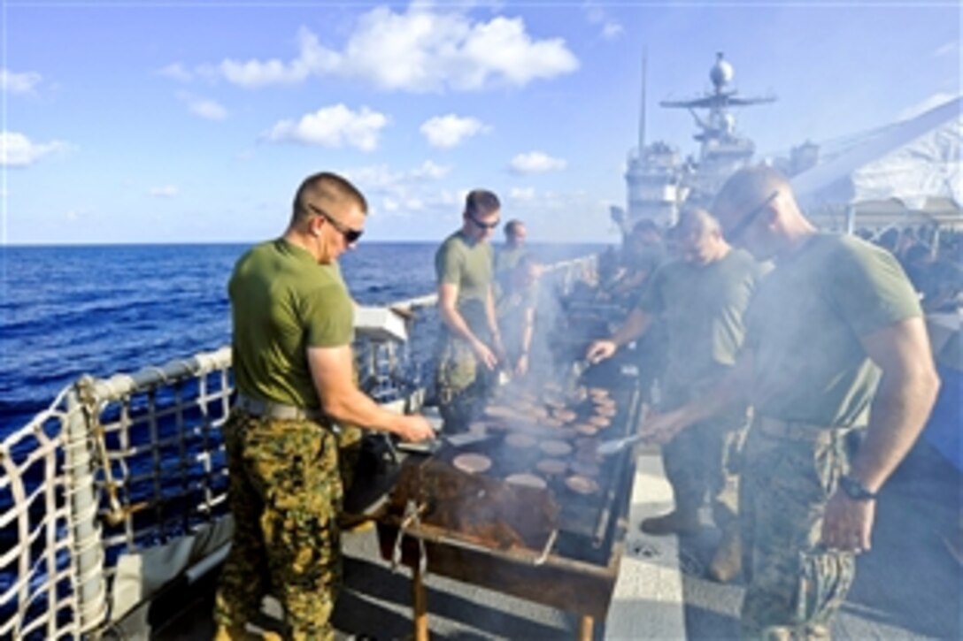 U.S. Marines grill hot dogs during a steel beach picnic aboard the amphibious dock landing ship USS Tortuga in the Pacific Ocean, Nov. 21, 2010. The Marines are assigned to the 31st Marine Expeditionary Unit.