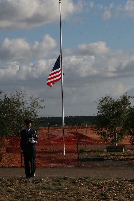 A lone bugler finishes a rendition of "Taps" at Miramar National Cemetery aboard Marine Corps Air Station Miramar, Calif., Nov. 22. Dignitaries buried four veterans and one spouse, marking the official opening of the new facility.