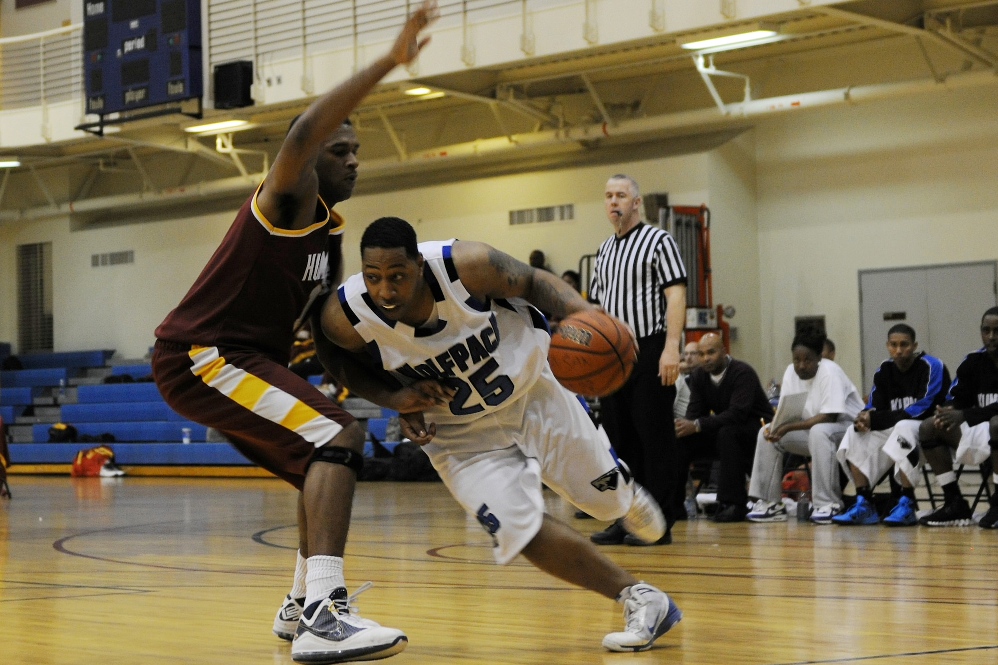 KUNSAN AIR BASE, Republic of Korea -- Wolf Pack forward, Daniel Johnson, drives around a Camp Humphreys defender during the Men's Varsity basketball game against Camp Humphreys Nov. 20-21 at the base gym. On both days the Wolf Pack men's team were the winners over Camp Humphreys scoring 76-52 on day one, and 78-76 on day two. (U.S. Air Force photo/Staff Sgt. Jonathan Pomeroy)
