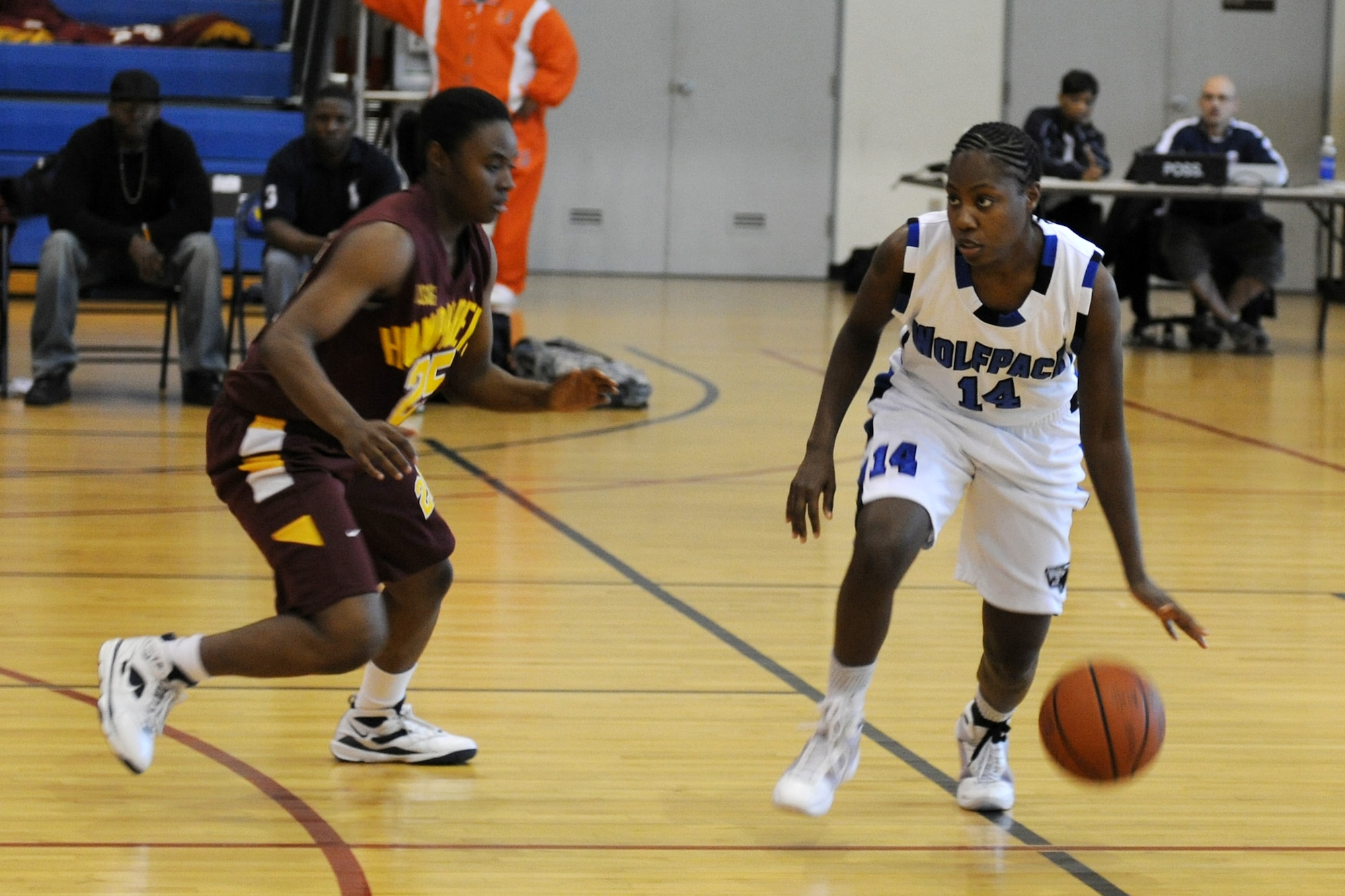 KUNSAN AIR BASE, Republic of Korea -- Wolf Pack forward Tashara Chisholm dribbles around a Camp Humphreys defender during the Women's Varsity basketball game Nov. 20-21 at the base gym.  Wolf Pack lost to Camp Humphreys scoring 43-56 on day one, and 51-57 on day two. (U.S. Air Force photo/Staff Sgt. Jonathan Pomeroy)
