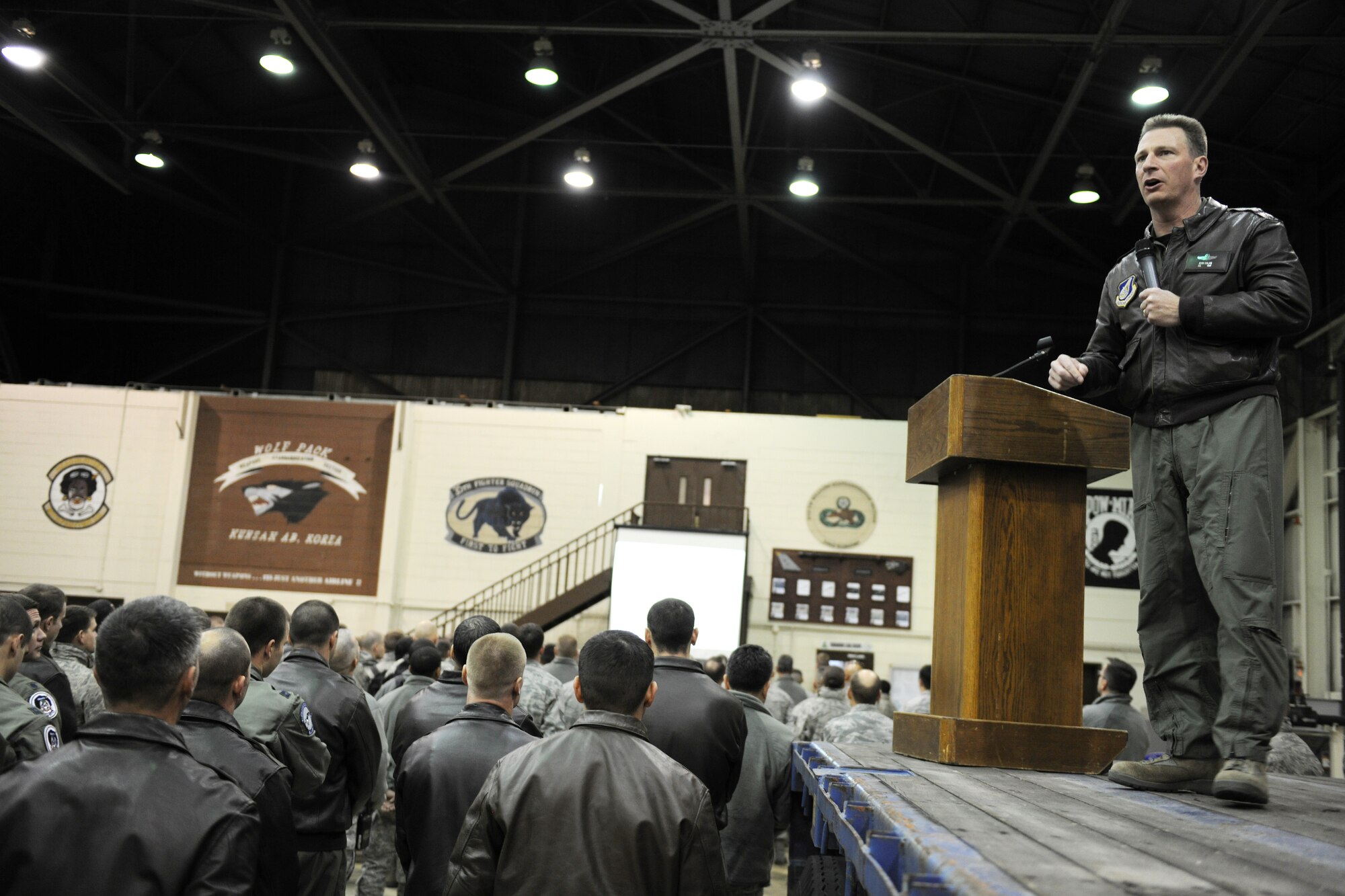 KUNSAN AIR BASE, Republic of Korea -- Col. John Dolan, 8th Fighter Wing commander, addresses base Airmen during a commander's call regarding the overall wing grade during a no notice readiness inspection in Hangar 3 Nov. 23.  The wing participated in the Phase 1 operational readiness inspection Beverly Bearcat 10-06 that tested the wing's prepartion and mobilization from peacetime readiness into wartime posture. (U.S. Air Force photo/Staff Sgt. Jonathan Pomeroy)
