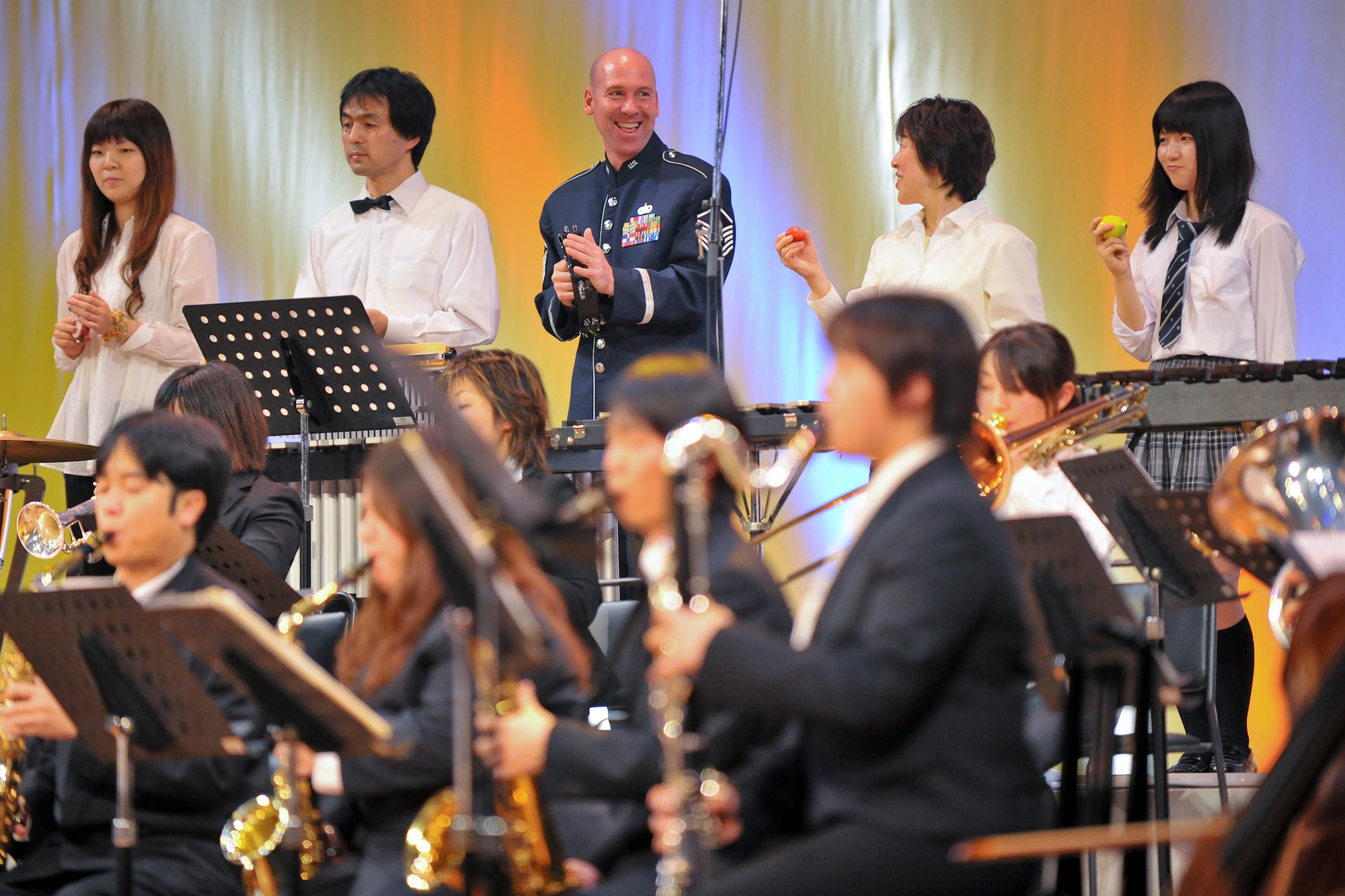 AKISHIMA, Japan -- Master Sgt. Vincent Dublino, U.S. Air Force Band of the Pacific-Asia, performs with the members of Akishima Youth Brass Band Nov.23 during the Japan-U.S. Joint concert in Akishima city. (U.S. Air Force photo/Osakabe Yasuo)