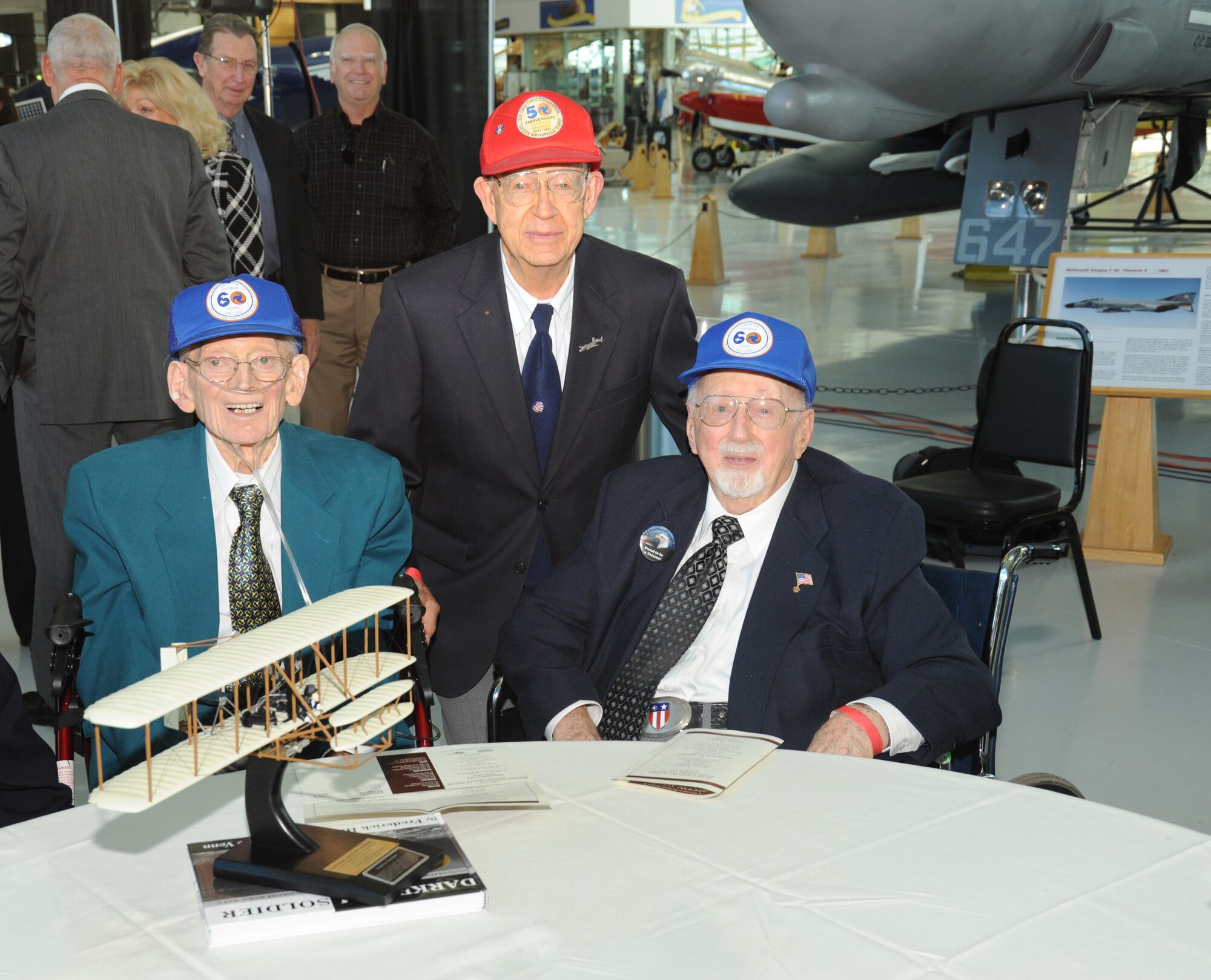 Glenn Curry, Fred Hill and Fred Parish pose with the "Wright Flyer" award given to the Oregon Air National Guard's 123rd Observation Squadron after the group was inducted into the Oregon Aviation Hall of Honor at the Evergreen Aviation and Space Museum in McMinnville, Ore., on October 17, 2010. Curry, Hill and Parish are three of the eight living original members of the 123rd Observation Squadron of the Oregon Air National Guard. 
