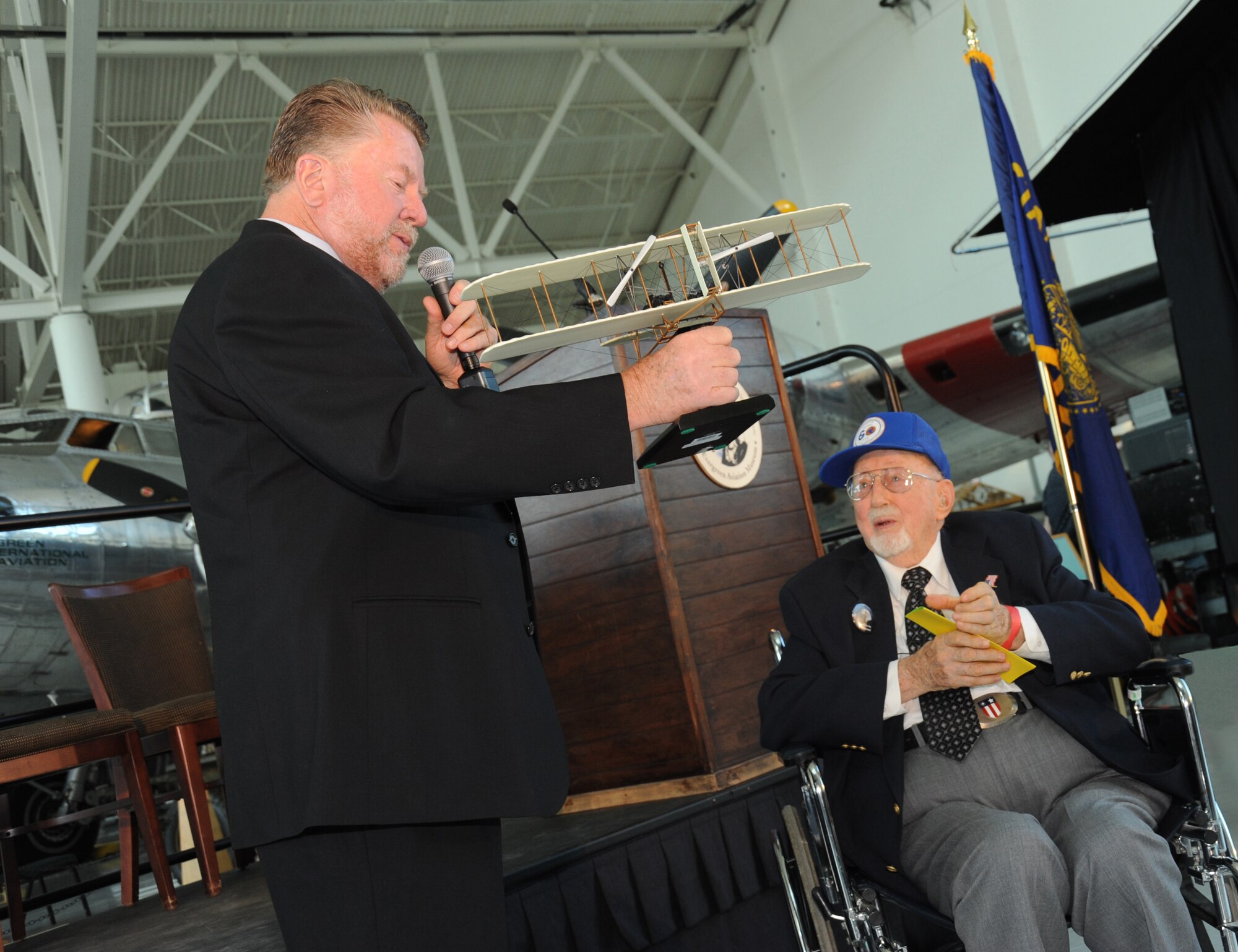 Mike Burrell, the Chairman of the selection committee for the Evergreen Aviation and Space Museum, presents the "Wright Flyer" award to Fred Parish during the  Oregon Aviation Hall of Honor Ceremony held at the Evergreen Aviation and Space Museum, McMinnville, Ore., on October 17, 2010. Parish was representing the 123rd Observation Squardron, which was the first group to be inducted into the Hall of Honor. He is one of only eight living original members still living from the group of 117 members of the 123rd Oregon National Guard's first aviation unit. (U.S. Air Force photograph by Staff Sgt. John Hughel, 142nd Fighter Wing Public Affairs Department) 