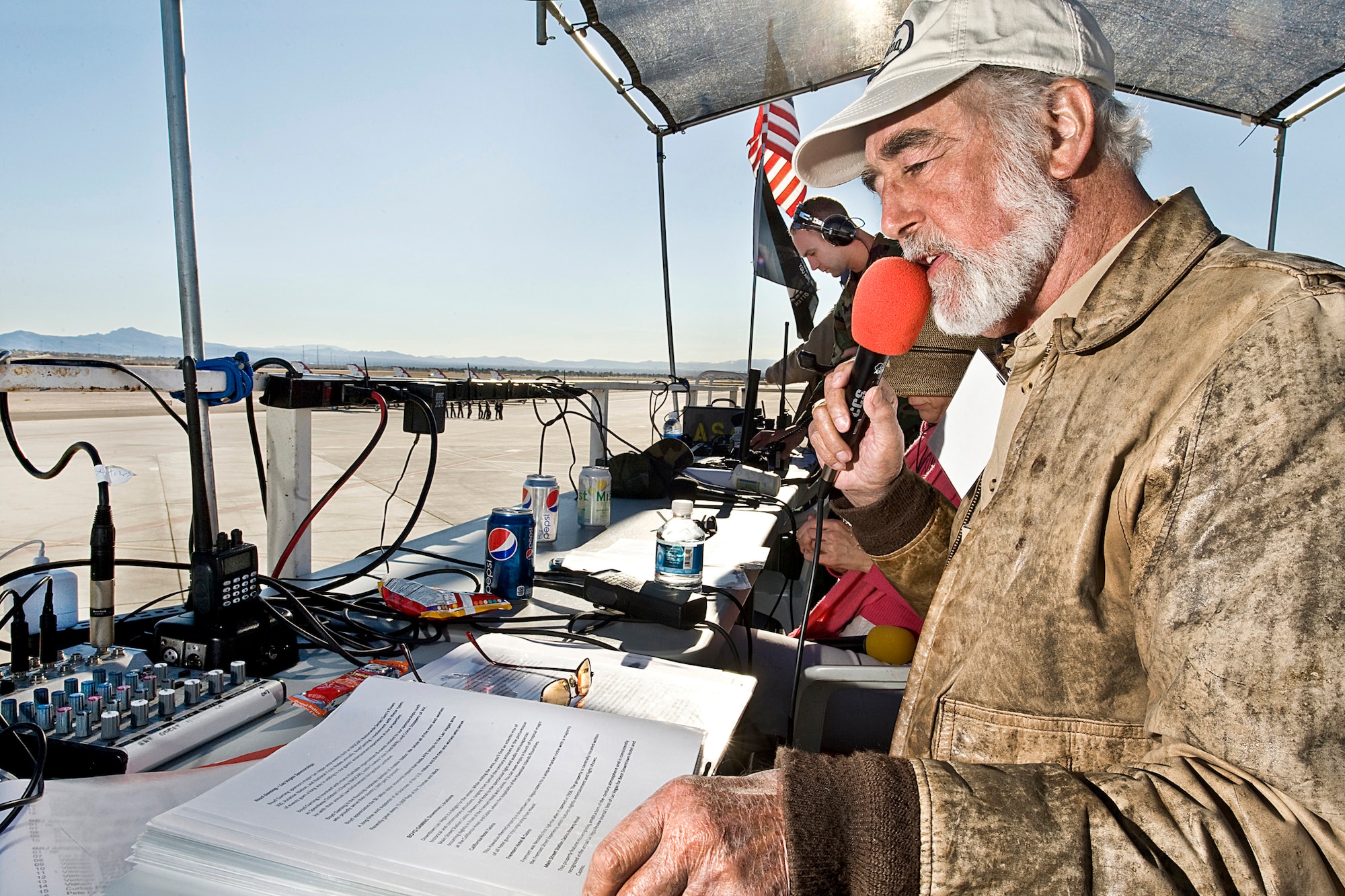 NELLIS AIR FORCE BASE, Nev.-- Gordon Bowman-Jones, the voice of the 2010 Aviation Nation Nellis Open House, introduces the U.S. Air Force Air Demonstration Squadron 'Thunderbirds' prior to their performance on Nov. 14.  Mr. Bowman-Jones has narrated more than 7,000 air shows and next year will mark his 40th anniversary as an air show announcer. (U.S. Air Force photo/ Lawrence Crespo) 






