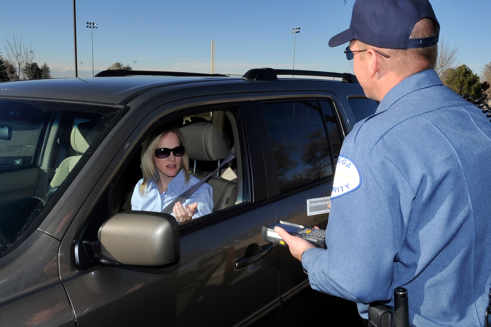 Officer Casey Lemieux, Chenega Security scans a Common Access Card with the new DBIDS system implemented at Buckley Air Force Base Nov 23, 2010. Buckley Identification Cards will be a one for one swap for the DBIDS card(U.S. Air Force photo by Airman 1st Class Paul Labbe.)