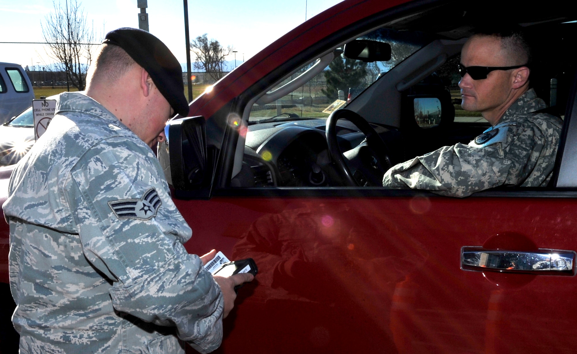 Senior Airman Derrick Morgan, 460th Security Forces Squadron scans a Common Access Card with the new DBIDS system implemented at Buckley Air Force Base Nov 23, 2010. This system is going to verify whether people are registered in DBIDS, or if their common access card has been reported lost or stolen, said Gilmore.(U.S. Air Force photo by Airman 1st Class Paul Labbe.)
