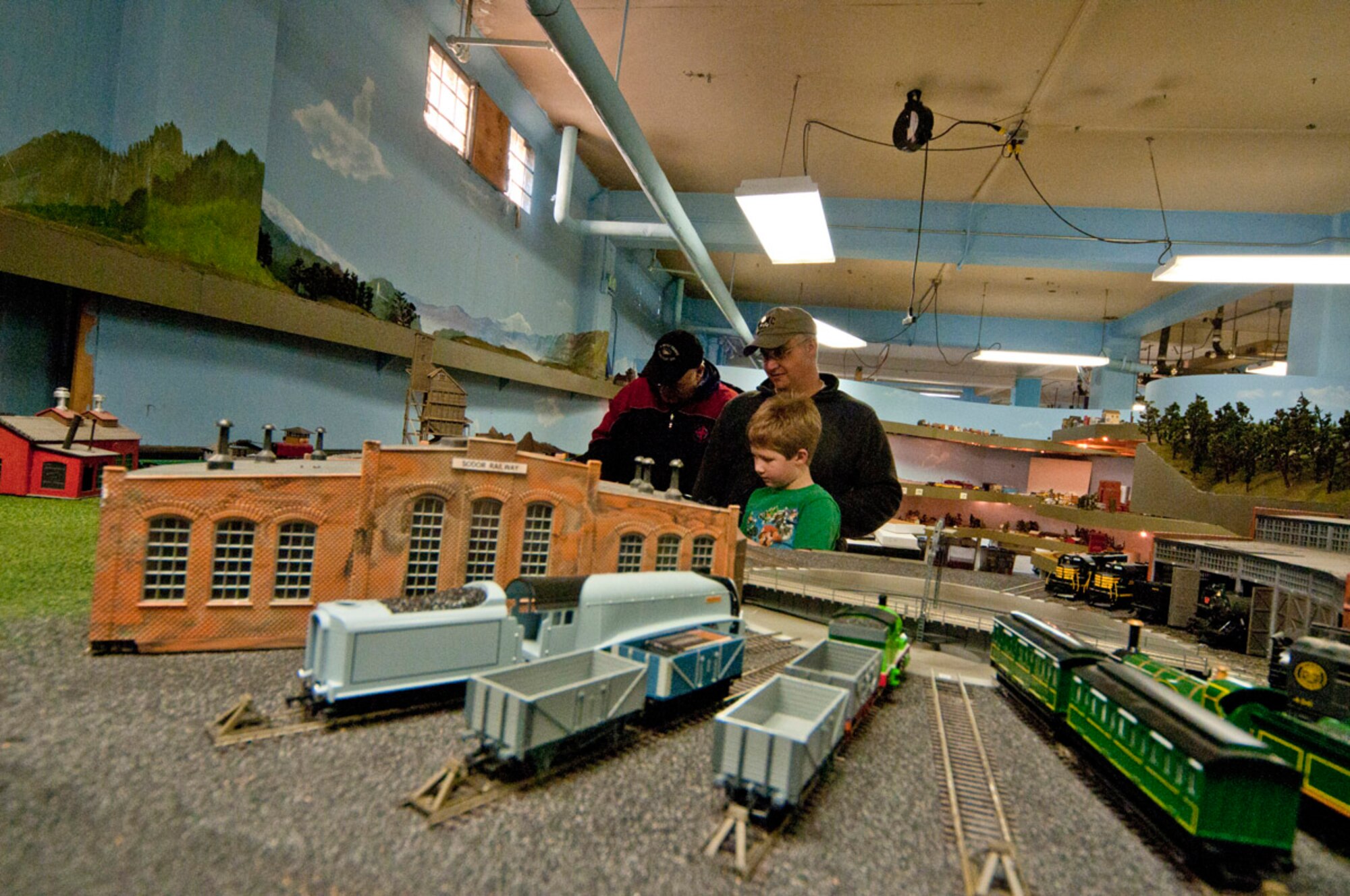 Lance Parcell watches as son Zachary control a train during the Military Society of Model Railroad Engineers open house, Nov. 20, at Matanuska Hall. (Photo by Steve White/JBER PAO)