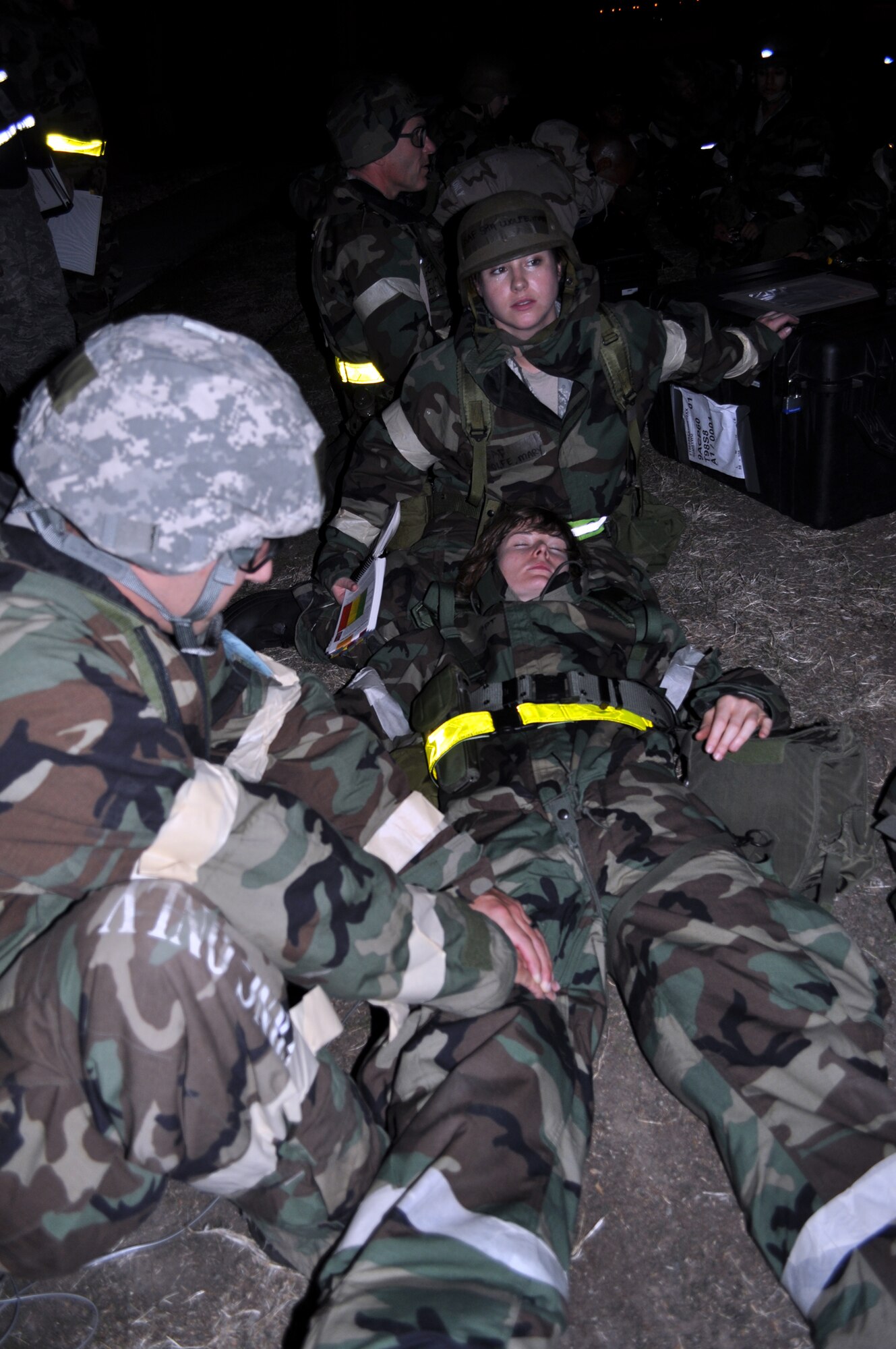 TRAVIS AIR FORCE BASE, Calif. -- Capt. Melissa Hueman, 349th AMW executive officer, lies wounded after a missile attack, as an unknown Airman applies pressure to her leg wound, and Senior Amn. Mary Wolfe cradles her head. The Airmen were hunkered down in simulated bunkers after bugging out of their burning building during
Exercise Crisis Look 10-07. During the bug out, the Captain was hit, and Airman Wolfe single-handedly dragged her out of the damaged building to safety, earning herself Outstanding Performer recognition. (U.S. Air Force photo/Senior Master Sgt. Ellen Hatfield)