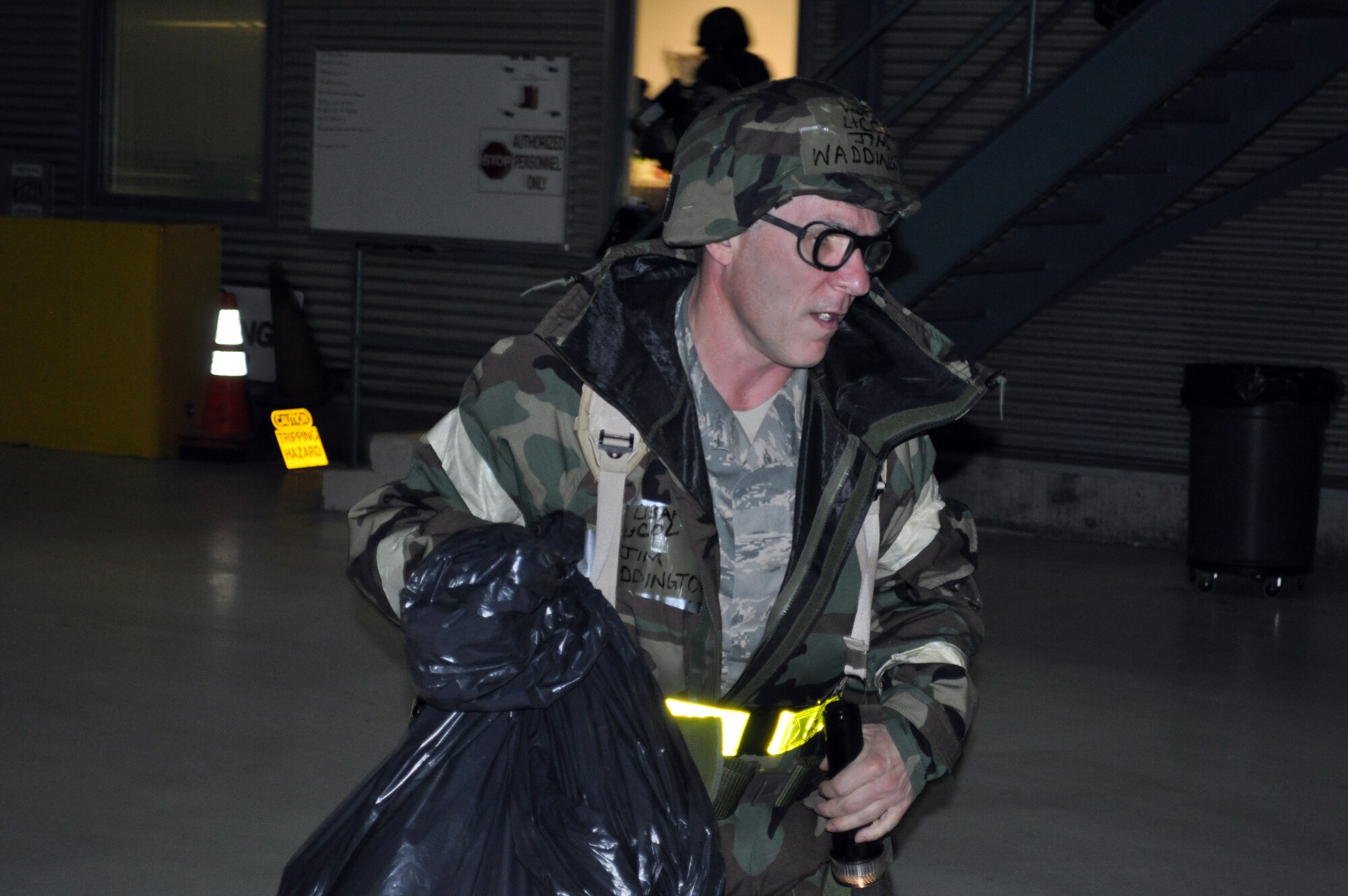 TRAVIS AIR FORCE BASE, Calif. -- Lt. Col. James Waddington, 349th AMW Emergency Operations Center staff officer, bugs out of his building that has been hit with missiles and is on fire, during Exercise Crisis Look 10-07 Nov. 4, 2010. These exercises test the ability of our Travis Airmen to survive and operate in an austere
location, under the most dire conditions. (U.S. Air Force photo/Senior Master Sgt. Ellen Hatfield)