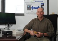 MINOT AIR FORCE BASE, N.D. -- Douglas Angell, 526th Intercontinental Ballistic Missile Systems Group technical engineer, poses with his invention, the launch control center NetLink, here Nov. 23. The LCC NetLink concept allows personal computing capability to crewmembers while on duty at the missile alert facilities. (U.S. Air Force Photo/Airman 1st Class Aaron-Forrest Wainwright)