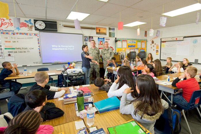 NELLIS AIR FORCE BASE, Nev.-- Catherine Hall and Airman 1st Class Timothy Bass, from the 99th Civil Engineers Squadron Geo Base office, and Master Sgt. Norman Harp, 99th CES Fire Protection, brief a fifth grade class at Lomie G. Heard Elementary School on geographic information systems Nov. 17 as part of the annual Geography Awareness Week.  The professional GIS users shared their knowledge with students and explained the impact the technology is making in our daily lives. (U.S. Air Force photo/ Lawrence Crespo)