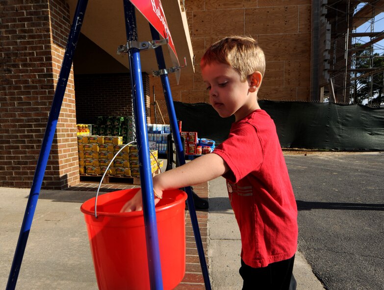 MOODY AIR FORCE BASE, Ga.-- Gabriel Jacobs, son of Tech. Sgt. Adam Jacobs and wife Cyndi, donates money to the Moody’s First Sergeants Council Nov. 23. The money collected will be used to support military families during the holiday season. (U.S. Air Force photo/Airman 1st Class Benjamin Wiseman)(RELEASED)