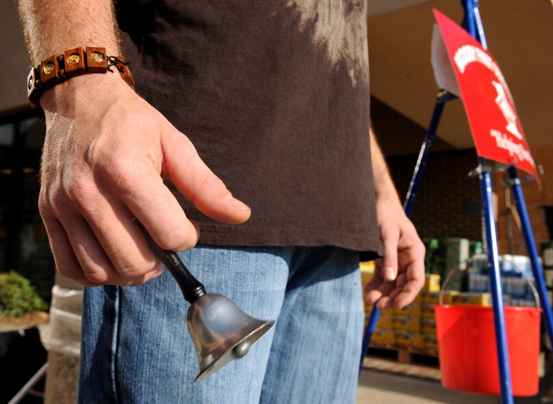 MOODY AIR FORCE BASE, Ga.-- A volunteer for the Moody’s First Sergeants Council rings a bell for donations outside the Commissary Nov. 23. Donation stations will be set up at the Base Exchange, Commissary and Shoppette throughout the holiday season. (U.S. Air Force photo/Airman 1st Class Benjamin Wiseman)(RELEASED)
