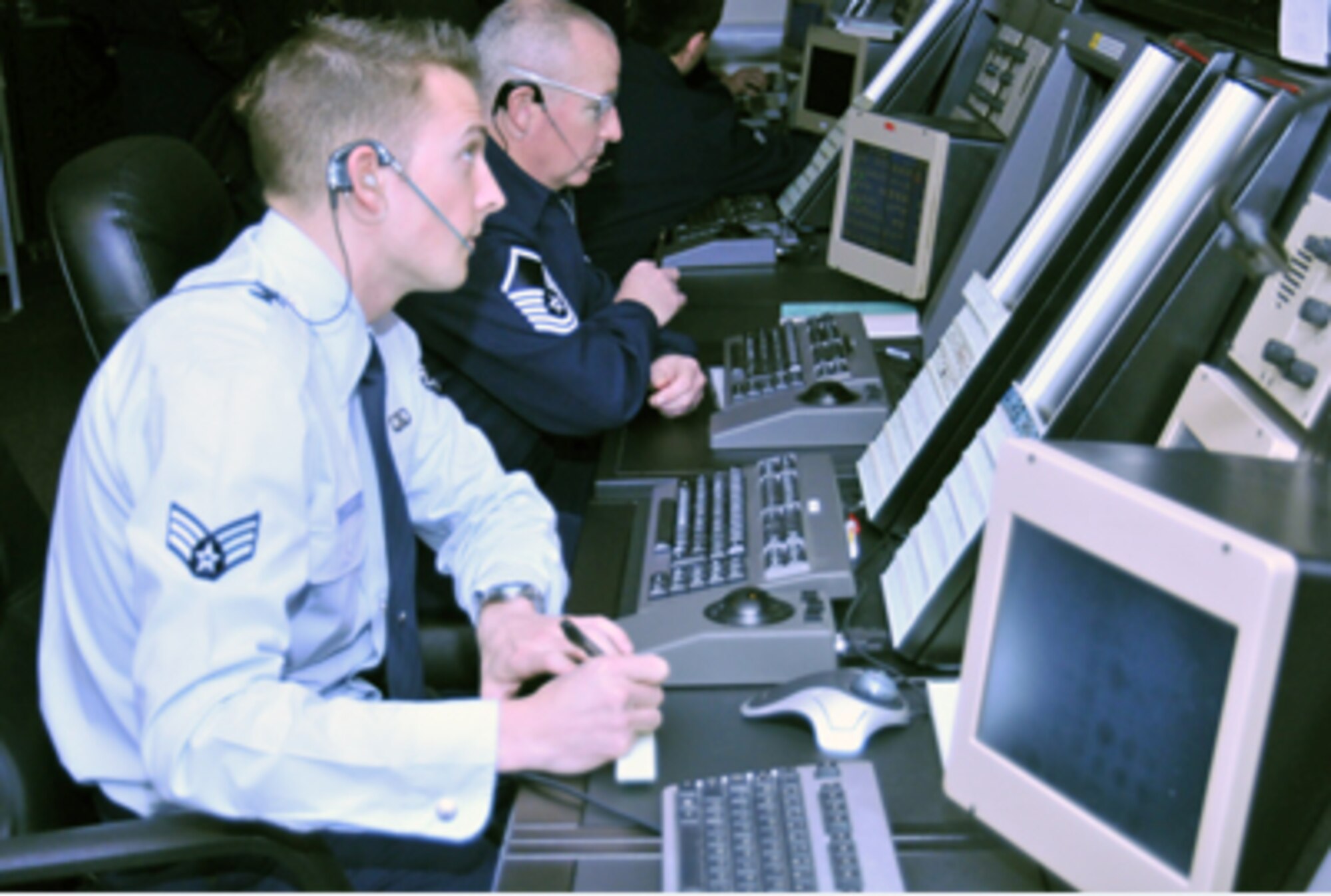 Senior Airman Jacob Tucker and Master Sgt. Jae Ewing monitor aircraft Nov. 22, 2010, in the Radar Approach Control facility at Royal Air Force Lakenheath, England. They are using new Standard Terminal Automation Replacement System equipment recently installed as part of a replacement program under the Air Force Electronic Systems Center and the Federal Aviation Administration. Airman Tucker is an air traffic control journeyman with the 48th Operation Support Squadron, and Sergeant Ewing is the 48th OSS senior watch supervisor. (U.S. Air Force photo/Senior Airman David Dobrydney)