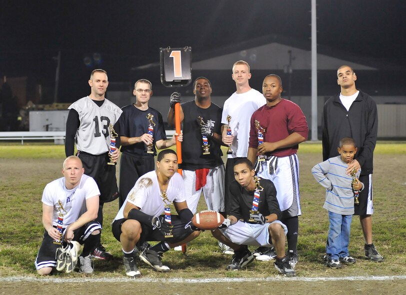 Members of the Dover Air Force Base, Del., flag football leagues pose with their trophies after the All Star Championship game Nov. 22, 2010. The American League took the title of champions by defeating the National League 19 – 13. The American League was made up of players from the 736th Aircraft Maintenance Squadron, 436 AMXS, 436th Logistics Readiness Squadron, 436th Communications Squadron and 436th Aerial Port Squadron.  The National League was made up of players from the 436th Medical Group, 436th Force Support Squadron and 436th Civil Engineer Squadron. (U.S. Air Force photo by Airman 1st Class Matthew Hubby/Released)