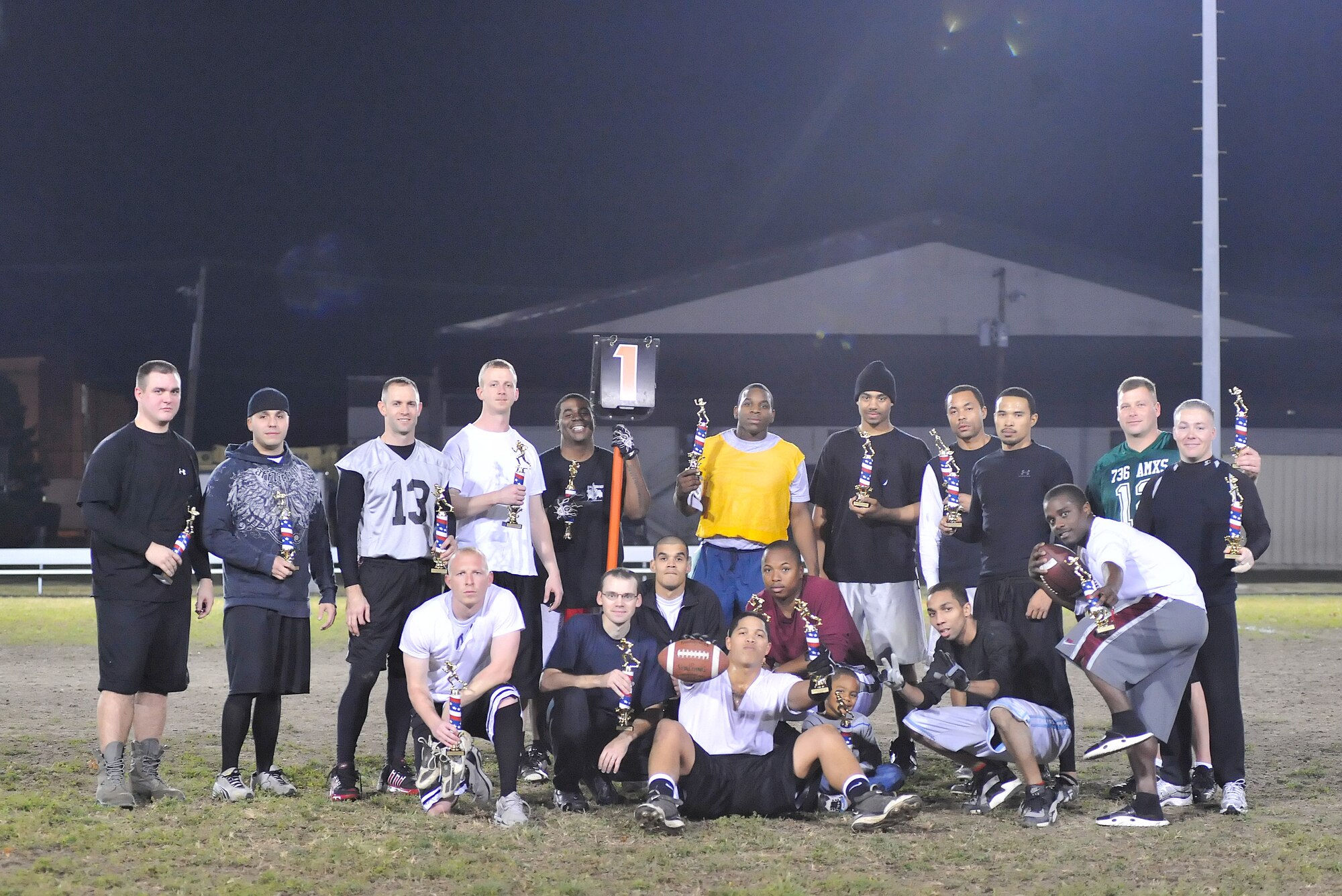 Members of the Dover Air Force Base, Del., flag football leagues pose with their trophies after the All Star Championship game Nov. 22, 2010. The American League took the title of champions by defeating the National League 19 – 13. The American League was made up of players from the 736th Aircraft Maintenance Squadron, 436 AMXS, 436th Logistics Readiness Squadron, 436th Communications Squadron and 436th Aerial Port Squadron.  The National League was made up of players from the 436th Medical Group, 436th Force Support Squadron and 436th Civil Engineer Squadron. (U.S. Air Force photo by Airman 1st Class Matthew Hubby/Released)