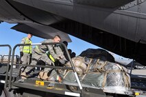 MINOT AIR FORCE BASE, N.D. -- Members of the 5th Logistics Readiness Squadron load team assist in loading cargo onto a C-130J Hercules here Nov. 8. AFGSC’s 5th Bomb Wing received a satisfactory rating after successfully completing its nuclear operational readiness inspection here Nov. 10. (U.S. Air Force photo/Senior Airman Michael J. Veloz)