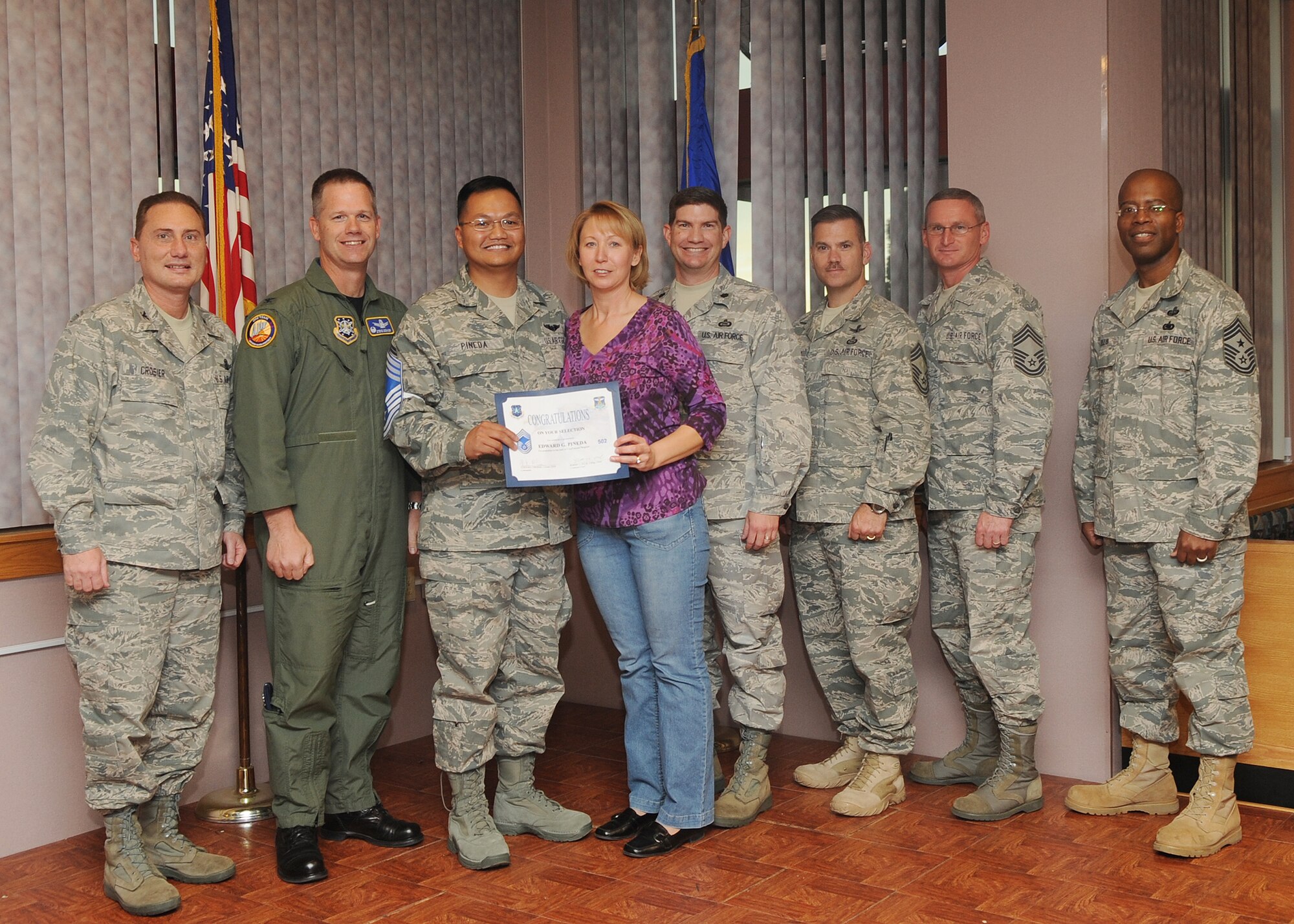 Buckley Air Force Base, Colo.-  Chief Master Sgt. (Select) Edward Pineda is congratulated by Col. Clinton Crosier and Chief Master Sgt. Robert Ellis during the Chief Promotion party held at Newtch's Den. ( U.S. Air Force Photo by Airman 1st Class Marcy Glass )
