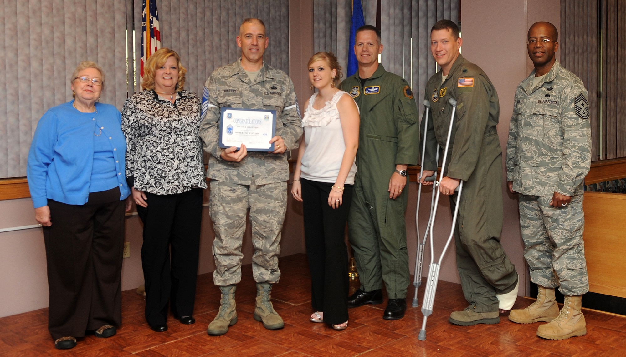 Buckley Air Force Base, Colo.-  Chief Master Sgt. (Select) Robert Winters is congratulated by Col. Clinton Crosier and Chief Master Sgt. Robert Ellis during the Chief Promotion party held at Newtch's Den. ( U.S. Air Force Photo by Airman 1st Class Marcy Glass )

