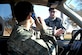 LANGLEY AIR FORCE BASE, Va. -- Staff Sgt. Jeff Tipton, a patrolman with the 633d Security Forces Squadron, simulates writing a cell phone violation ticket to 2nd Lt. John Cooper, 633d Air Base Wing Public Affairs deputy chief, Nov. 23. Using cell phones without hands-free equipment while driving is against base regulation. Military personnel caught breaking this rule will have citations sent to their commanders and first sergeants, and civilian offenders will receive a $106 fine. (U.S. Air Force photo/Staff Sgt. Ashley Hawkins) (RELEASED)