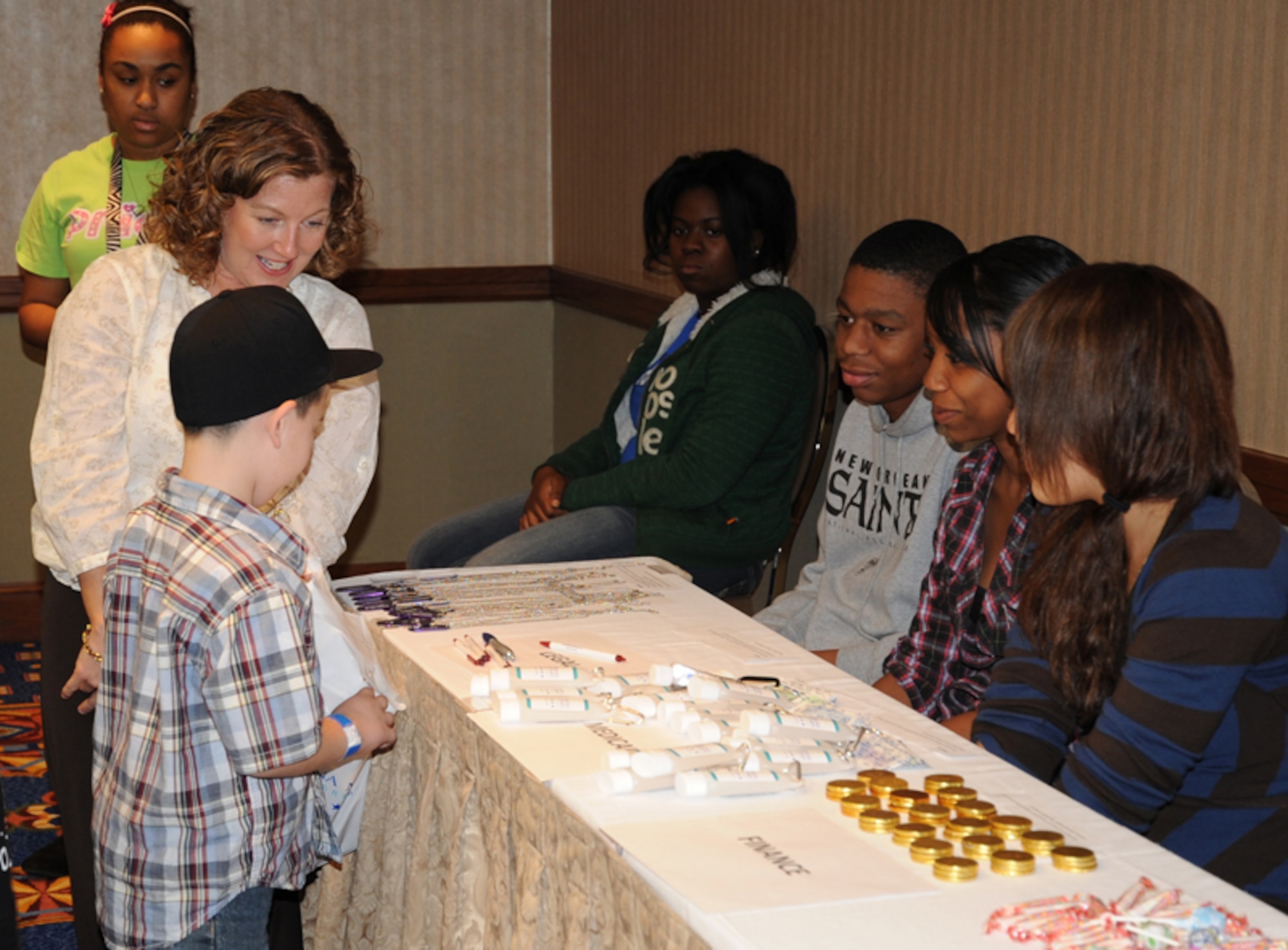 Capt. Lori Mann, 919th Special Operations Wing, Eglin Air Force Base, Fla. (left) explains the process to children going through a mock deployment line at the Hilton Memphis Hotel, Memphis, Tenn., Nov. 20, 2010 at the Yellow Ribbon Program. The children, who were dependents of service members attending YRP, were cared for during the conference free of charge. (U.S. Air Force photo by Senior Airman Anna-Marie Wyant)