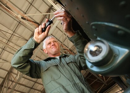 Col. William H. Mott V, 37th Training Wing commander, removes the left side of the intermediate gearbox cowling on a UH-1H helicopter Nov. 18. Colonel Mott was participating in the UH-1H helicopter drive train demonstration and performance exercise at the Inter-American Air Forces Academy Helicopter Basic Course. (U.S. Air Force photo/Robbin Cresswell)