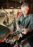 Col. William H. Mott V, 37th Training Wing commander, removes the attachment hardware of the tail rotor driveshaft assembly on the UH-1H helicopter during his visit to the Inter-American Air Forces Academy hangar Nov. 18. Colonel Mott was a guest in the Helicopter Basic Course. (U.S. Air Force photo/Robbin Cresswell) 