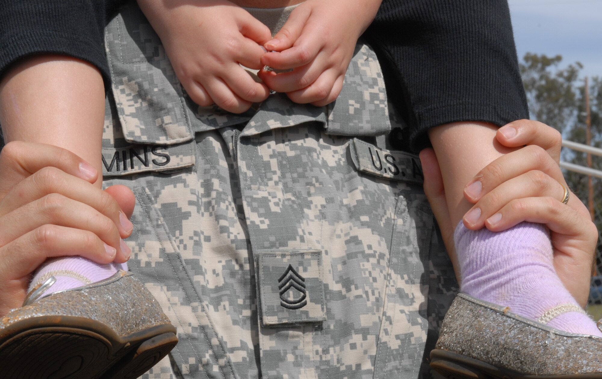 A Soldier and his daughter watch the 2010 Hawaiian Islands Working Dog Competition at Schofield Barracks, Hawaii, Nov. 19. Thirty-nine handlers from the U.S. Army, Navy, Marine Corps, and Air Force, as well as the Honolulu Police Department, Japan, Alaska, Ft. Huachuca, and Ft. Leonard Wood brought their K-9s through a series of events last week that served to both reward the dog teams for their hard work throughout the year and bring different services together. (U.S. Air Force photo/Staff Sgt. Carolyn Viss)