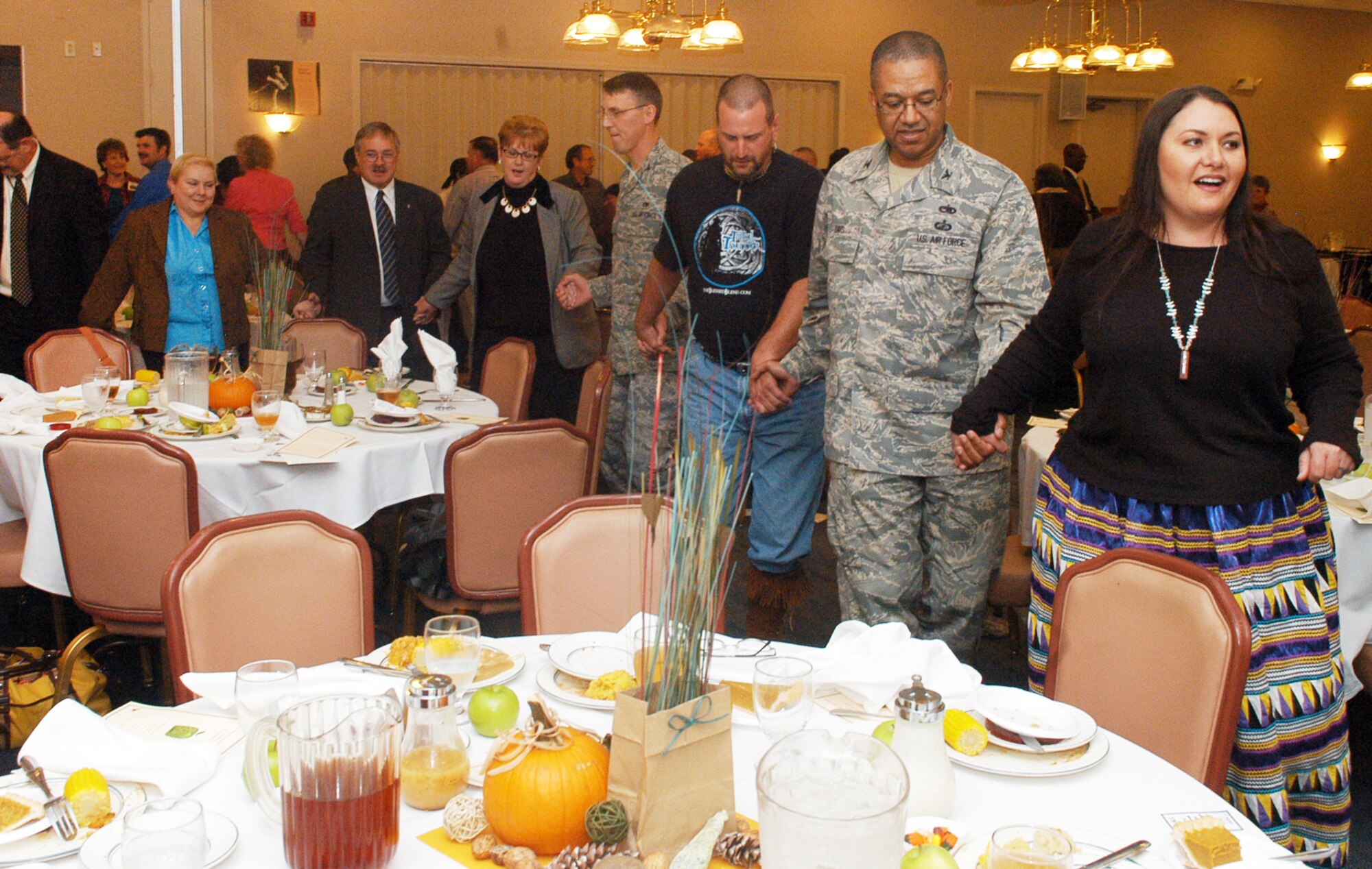 Laralyn Riverwind, right, leads attendees to the Native American Heritage Observance luncheon in a traditional dance. U. S. Air Force photo by Sue Sapp 