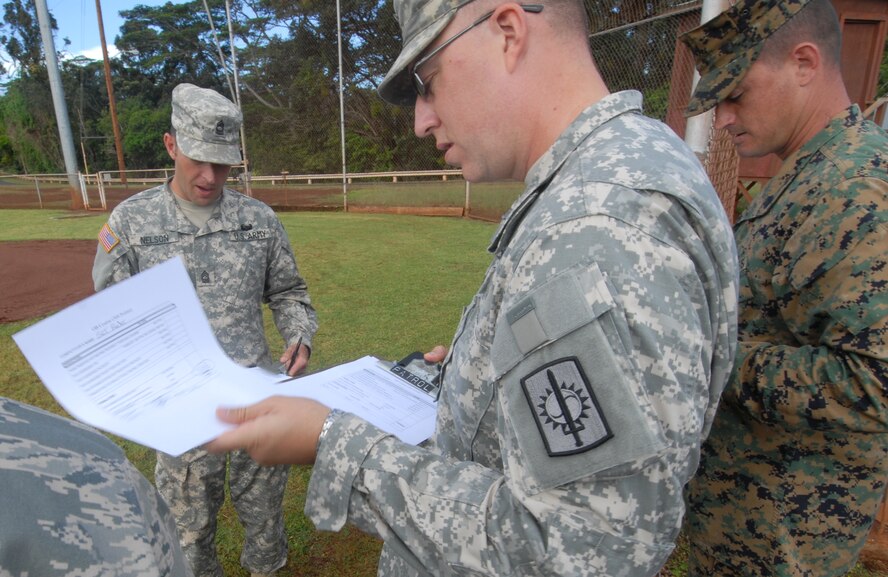 Joint-service judges assess the results of the obedience course during the 2010 Hawaiian Islands Working Dog Competition at Schofield Barracks, Hawaii, Nov. 19. Thirty-nine handlers from the U.S. Army, Navy, Marine Corps, and Air Force, as well as the Honolulu Police Department, Japan, Alaska, Ft. Huachuca, and Ft. Leonard Wood brought their K-9s through a series of events last week that served to both reward the dog teams for their hard work throughout the year and bring different services together. (U.S. Air Force photo/Staff Sgt. Carolyn Viss)
