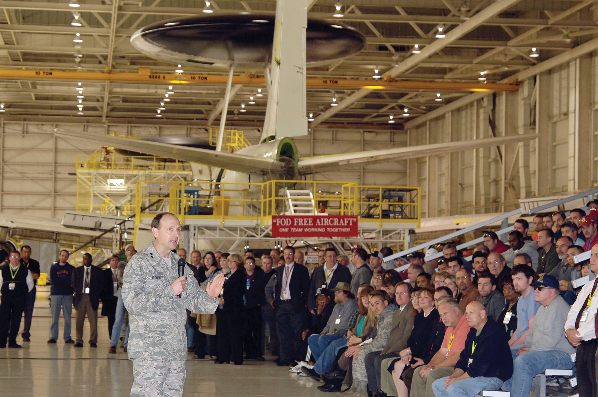 Maj. Gen. Bruce Litchfield, 76th Maintenance Wing commander, addresses a crowd made up of personnel from Tinker, Boeing Seattle and Boeing Oklahoma City and the Air Force Electronic Systems Center at Hanscom AFB, Mass., who gathered at Tinker Nov. 18 to celebrate the official kick-off of the $2.9 billion upgrade to computer and ground systems on the Air Force’s fleet of E-3 Sentry Airborne Warning and Control Systems aircraft. Work began on the first aircraft here Nov. 22 and is scheduled to continue through 2020. (Air Force photo by Margo Wright)