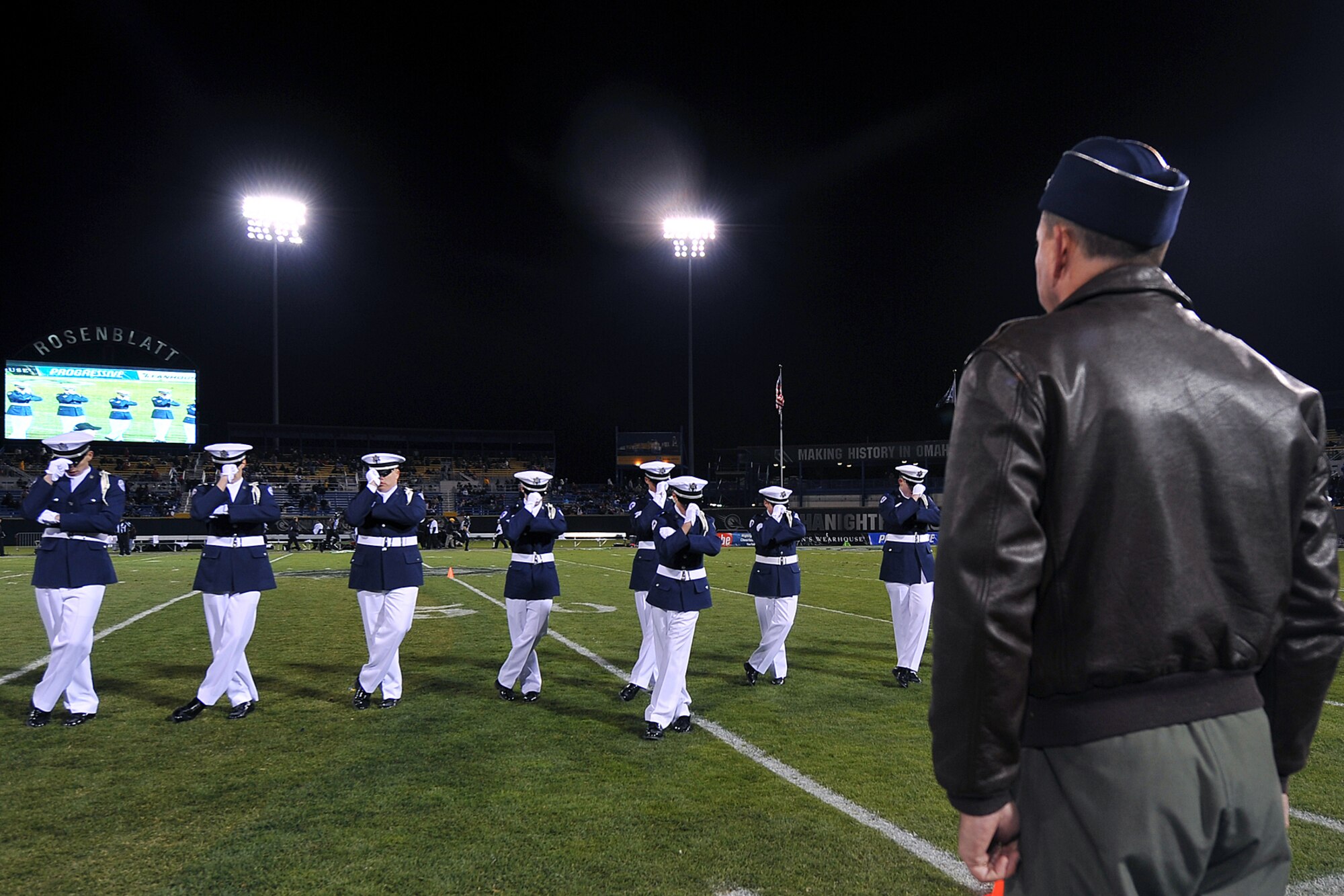 OFFUTT AIR FORCE BASE, Neb. - The Bellevue West High School Air Force Junior ROTC drill team performs while Brig. Gen. John N.T. Shanahan, 55th Wing commander, watches their drill movements during the Omaha Nighthawks military appreciation game at the Rosenblatt Stadium Nov. 19. Military members from all branches were celebrated at the game, which ended with a Florida Tuskers win 27 - 10. U.S. Air Force Photo by Charles Haymond (Released) 