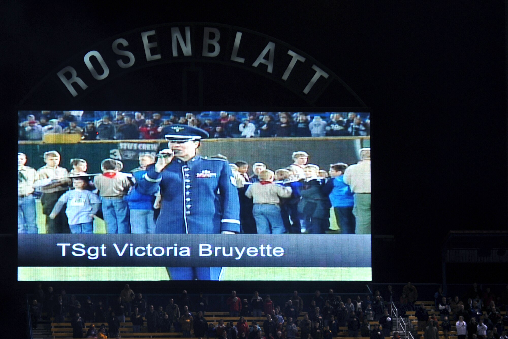 OFFUTT AIR FORCE BASE, Neb. - Technical Sgt. Victoria Bruyette, a vocalist with Air Combat Command's Heartland of America Band, sings the national anthem during the Omaha Nighthawks military appreciation game at the Rosenblatt Stadium Nov. 19. Military members from all branches were celebrated at the game, which ended with a Florida Tuskers win 27 - 10. U.S. Air Force Photo by Charles Haymond (Released)