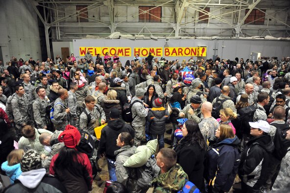 MINOT AIR FORCE BASE, N.D. -- Airmen are greeted in a grand fashion by their families during the re-deployment here Nov. 20. These Airmen arrived from their deployment to Andersen AFB, Guam, as part of U.S. Pacific Command’s Continuous Bomber Presence. (U.S. Air Force photo/Senior Airman Michael J. Veloz)
