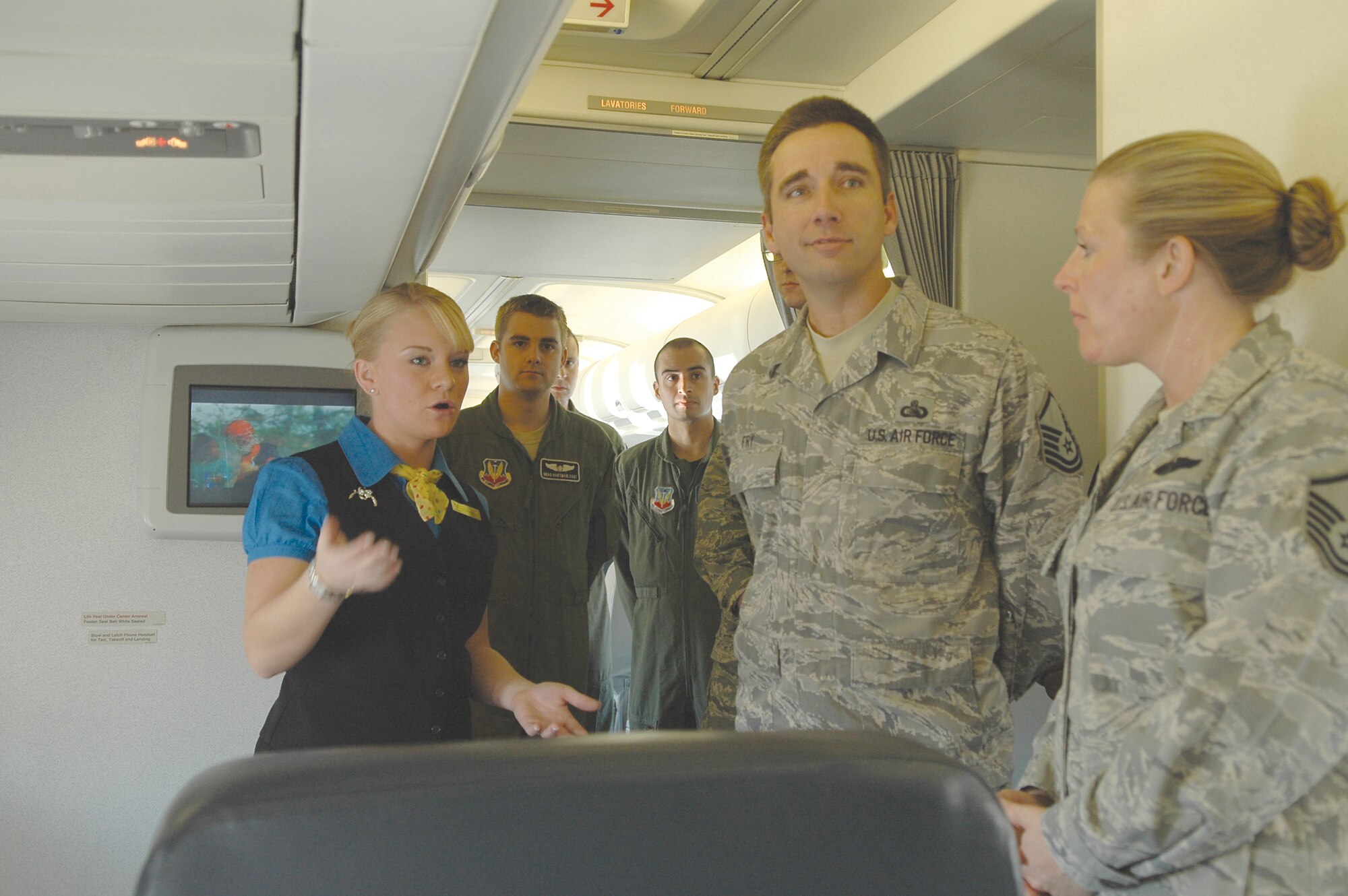 Staff Sgt. Amanda Fauci, a flight attendant with the 89th Airlift Wing, gives members of Team Tinker a tour of the C-32A transport aircraft. The 150-foot plane, has several different seating areas, a wide array of communications gear and on-board galleys for meals. It is used by dignitaries from the vice president to the chairman of the joint chiefs of staff. The Tinker visit was for a dual purpose, training for the crew and an opportunity for Tinker Airmen to see the special-duty opportunities available with the 89th AW, based at Andrews AFB, Va. (Air Force photo by Micah Garbarino)
