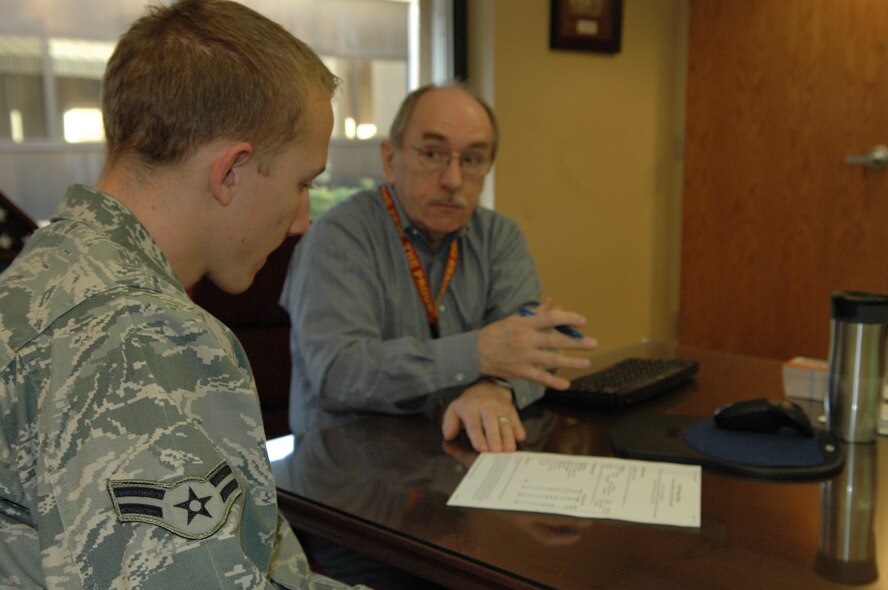 J.D. Coy, an education counselor with the 72nd Force Support Squadron Education Services Office, goes over a Community College of the Air Force education plan with Airman 1st Class Waylon Branscom, 72nd Medical Group. Airman Branscom wants to become a teacher when he is finished with his military career. The 72nd Medical Group set up a site visit for Mr. Coy to provide education counseling to Airmen without them having to leave the clinic. (Air Force photo by Micah Garbarino)