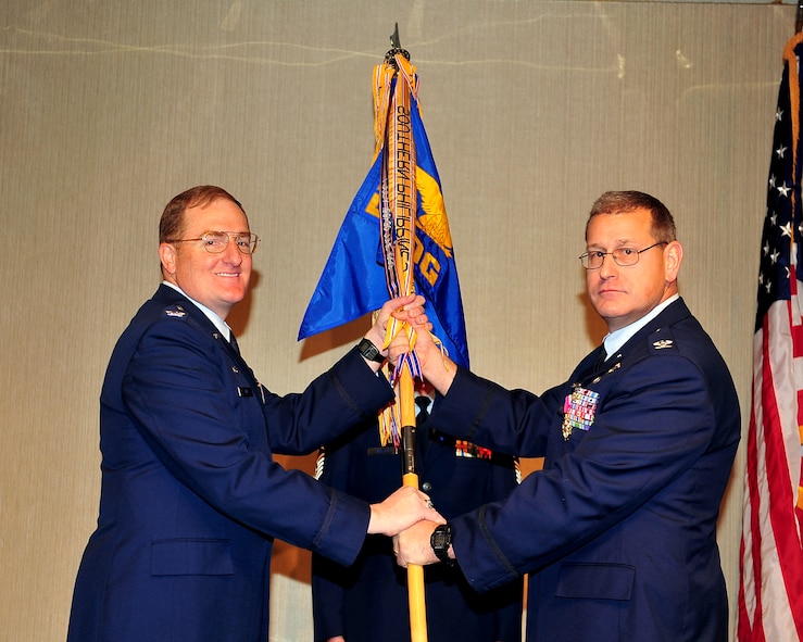 MINOT AIR FORCE BASE, N.D. -- Col. Charles Patnaude, 5th Operations Group commander, relinquishes command to Col. Douglas Cox, 5th Bomb Wing commander, during a change of command ceremony here Nov. 19. (U.S. Air Force photo/Senior Airman Michael J. Veloz)