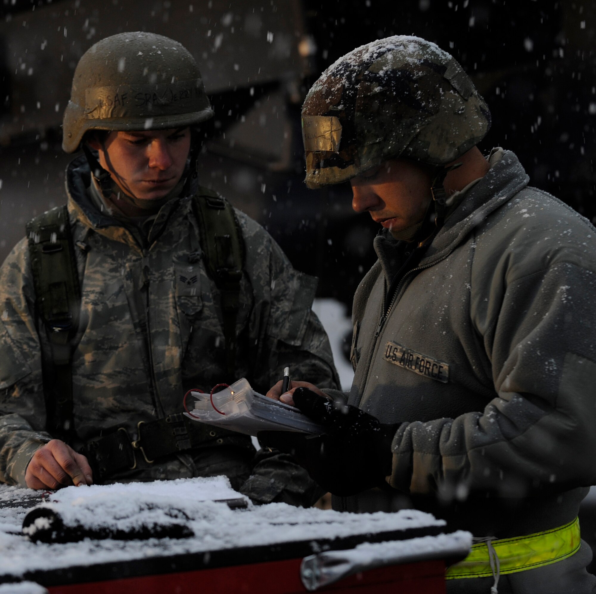 MOUNTAIN HOME AIR FORCE BASE, Idaho -- Senior Airman Jerry Haack and Staff Sgt. Peter Sterling, both 366th Aircraft Maintenance Unit weapons, review a checklist before continuing maintenance on an F-15E Strike Eagle during a phase I operational readiness exercise Nov. 22. The wing uses OREs to gauge its ability to meet wartime taskings at a deployed location. The evaluation includes initial response, readiness, combat operations, ability to survive and operate, self aid and buddy care and mission support. (U.S. Air Force photo by Senior Airman Renishia Richardson)