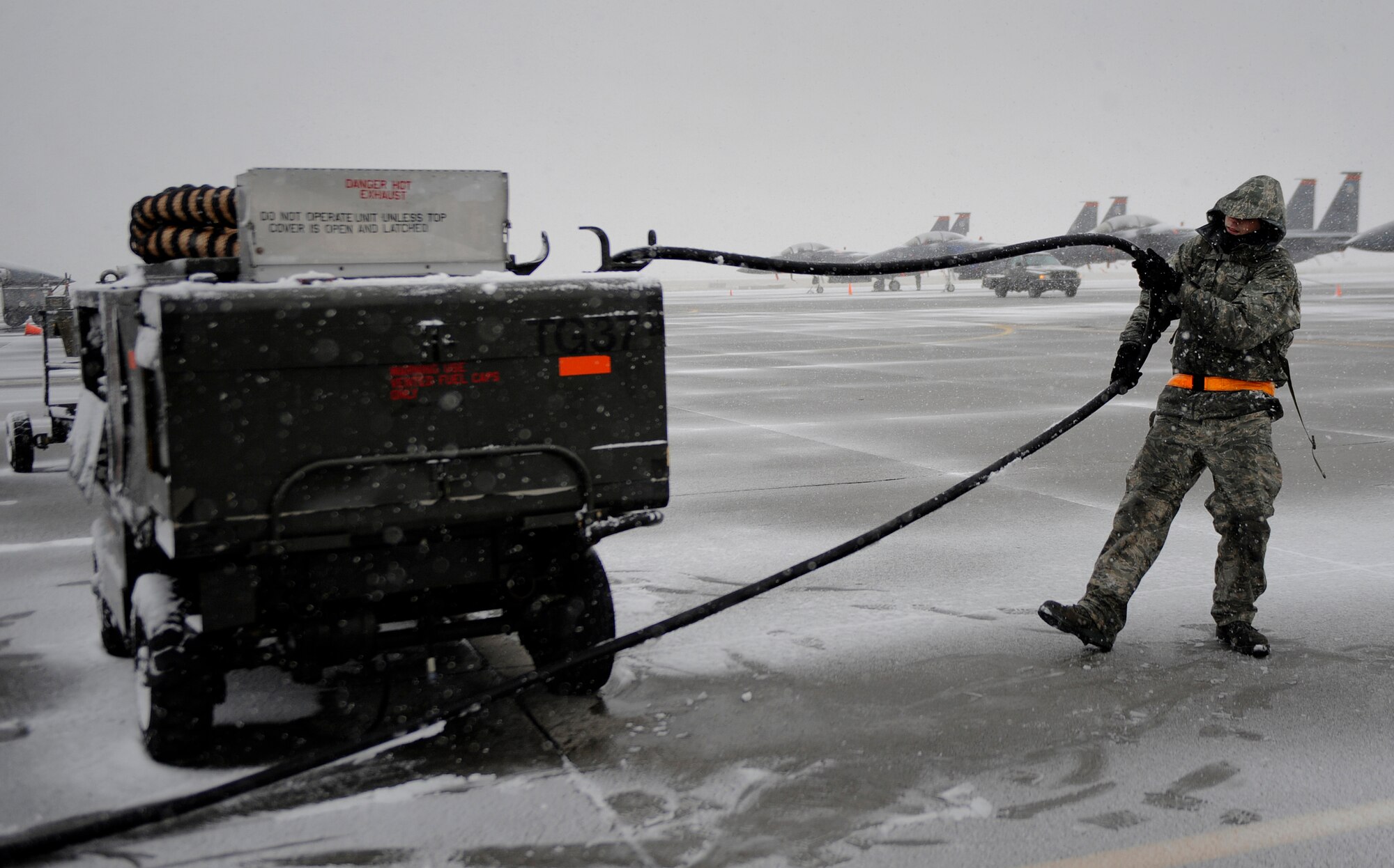 MOUNTAIN HOME AIR FORCE BASE, Idaho -- Senior Airman Gavin Washburn, 391st Aircraft Maintenance Unit crew chief, puts a hose away during an operational readiness exercise here Nov. 21. The wing uses OREs to gauge its ability to meet wartime taskings at a deployed location. The evaluation includes initial response, readiness, combat operations, ability to survive and operate, self aid and buddy care and mission support. (U.S. Air Force photo by Senior Airman Renishia Richardson)