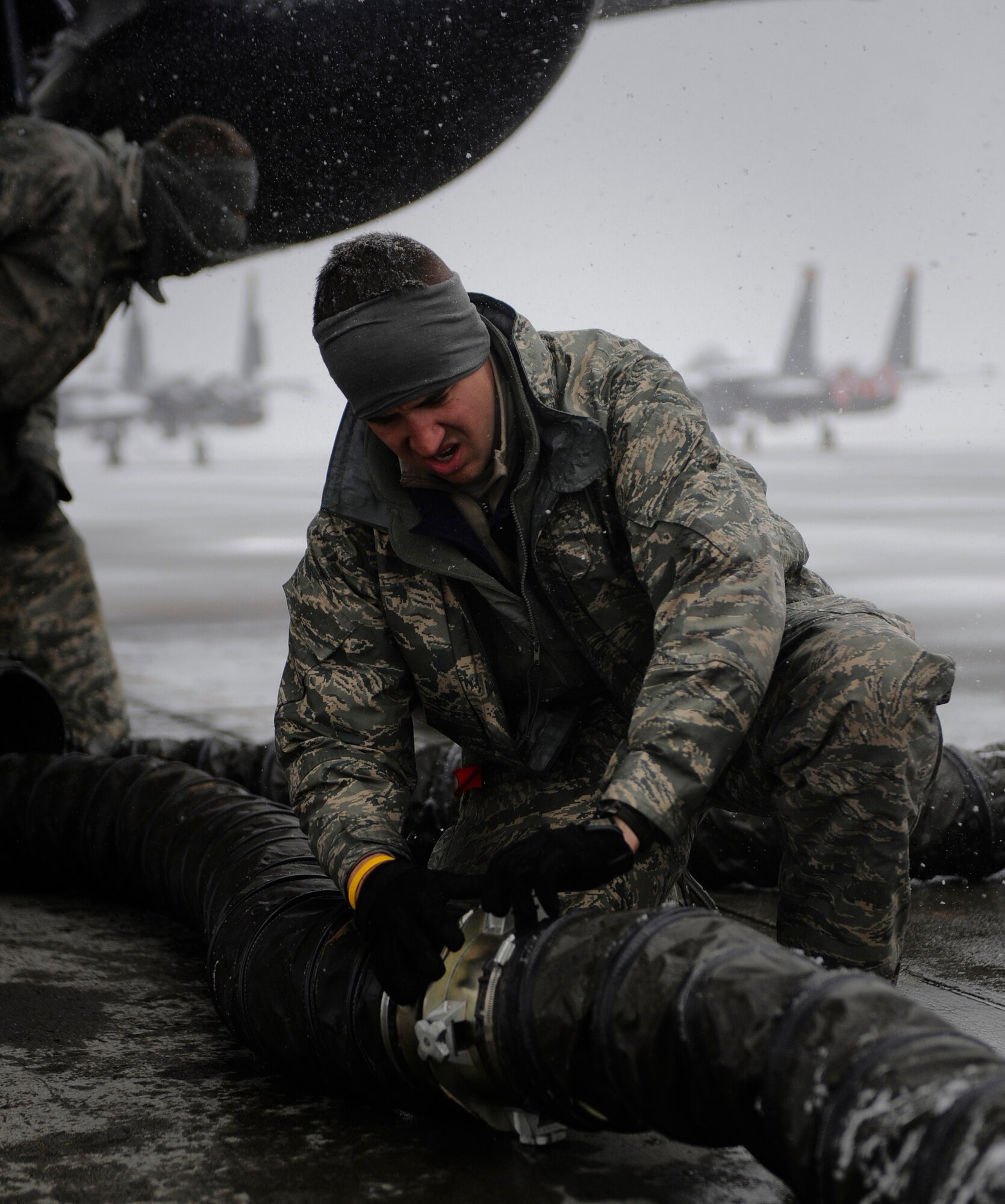 MOUNTAIN HOME AIR FORCE BASE, Idaho -- Senior Airman Joseph Dotson, 391st Aircraft Maintenance Unit crew chief, disconnects a hose during an operational readiness exercise here Nov. 21. The wing uses OREs to gauge its ability to meet wartime taskings at a deployed location. The evaluation includes initial response, readiness, combat operations, ability to survive and operate, self aid and buddy care and mission support. (U.S. Air Force photo by Senior Airman Renishia Richardson)