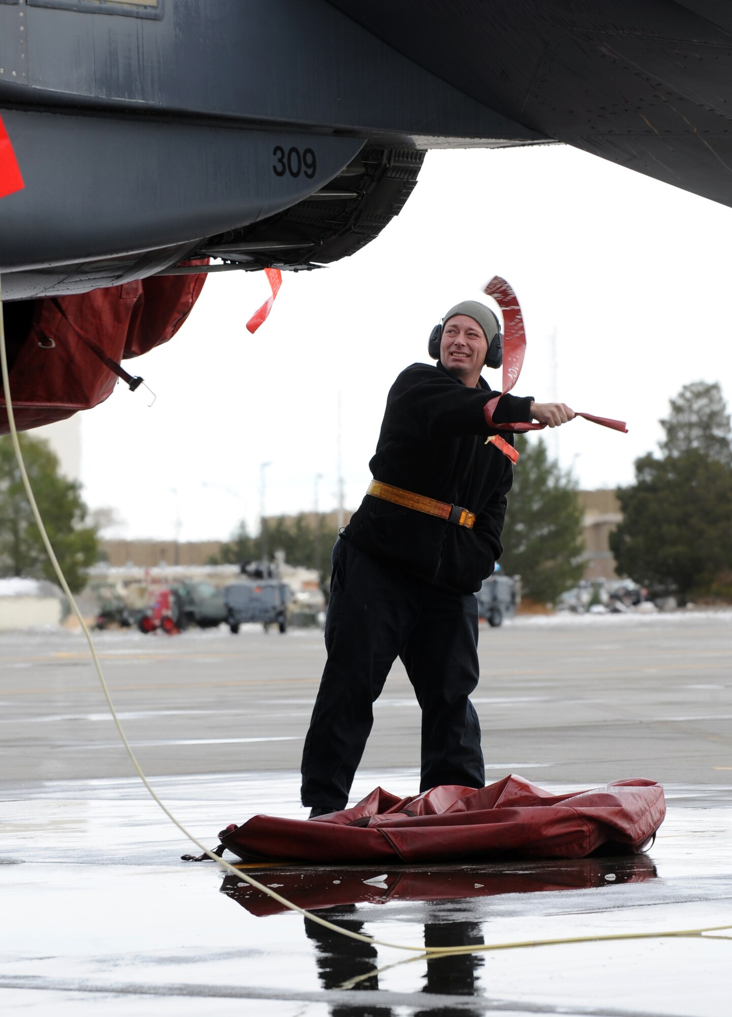 MOUNTAIN HOME AIR FORCE BASE, Idaho -- Senior Airman Ken Wright, 391st Aircraft Maintenance Unit crew chief, removes a cover from an engine exhaust of an F-15E Strike Eagle during a phase one operational readiness exercise Nov. 22. The base uses exercises to increase readiness and enhance the efficiency of processing combat-ready Airmen. (Senior Airman Debbie Lockhart)