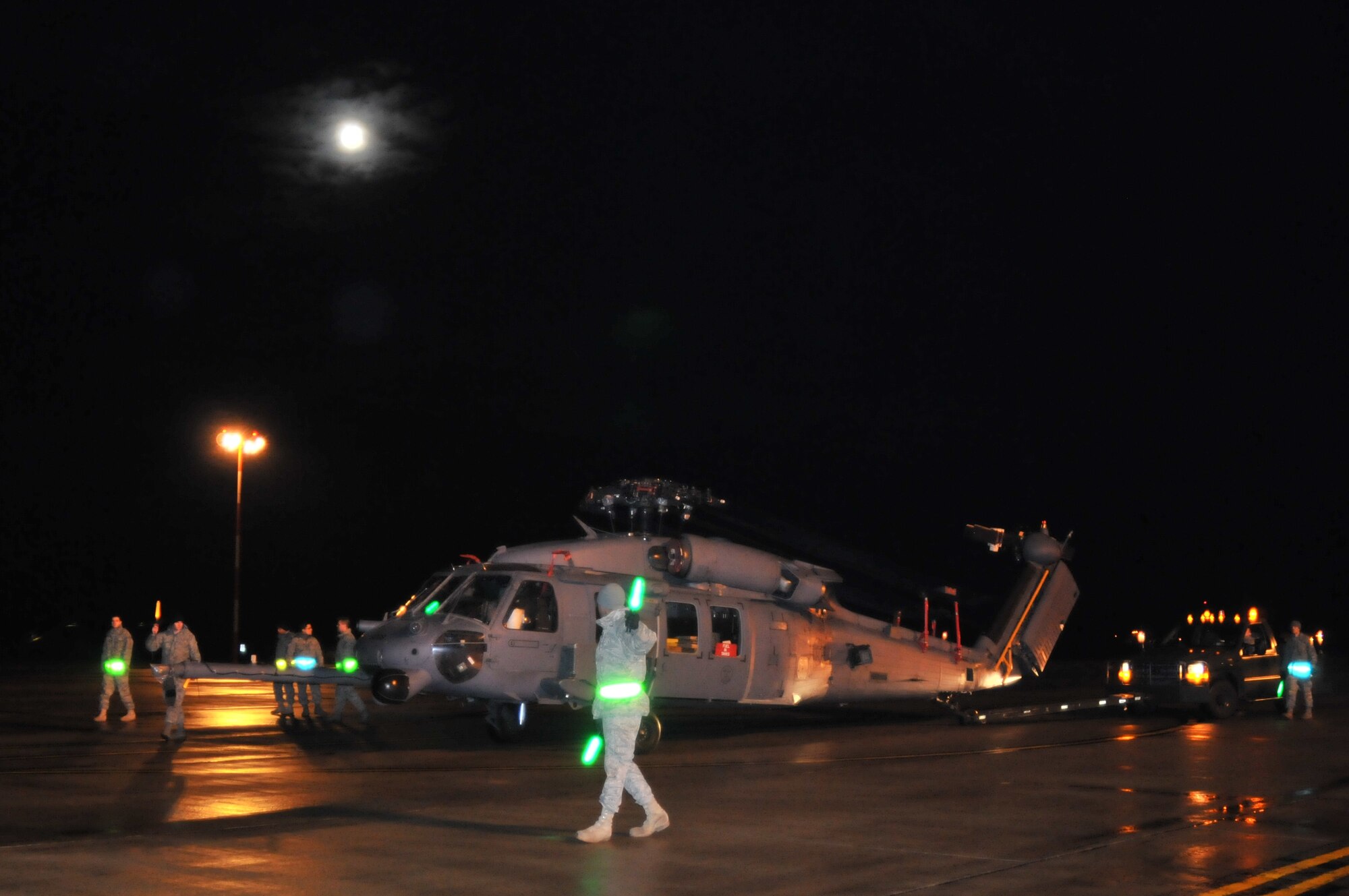 ROYAL AIR FORCE LAKENHEATH, England -- Airmen from the 748th Aircraft Maintenance Squadron guide an HH-60G Pave Hawk helicopter as it is pushed toward a waiting C-17 Globemaster III on Nov. 22. The 56th Rescue Squadron sent two helicopters to Afghanistan as part of an upcoming deployment. (U.S. Air Force photo/Senior Airman David Dobrydney)