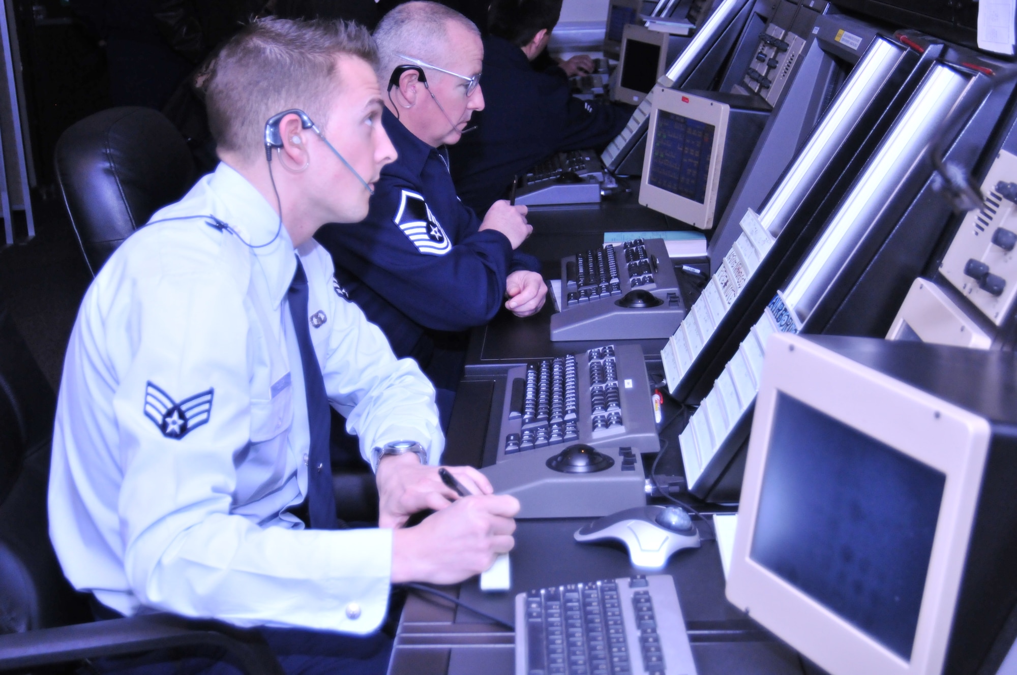 ROYAL AIR FORCE LAKENHEATH, England -- Senior Airman Jacob Tucker, 48th Operation Support Squadron air traffic control journeyman, and Master Sgt. Jae Ewing, 48th OSS senior watch supervisor, monitor aircraft in the Radar Approach Control facility Nov. 22. They are using new Standard Terminal Automation Replacement System equipment recently installed as part of a replacement program under the Air Force Electronic Systems Center and the Federal Aviation Administration. (U.S. Air Force photo/Senior Airman David Dobrydney)