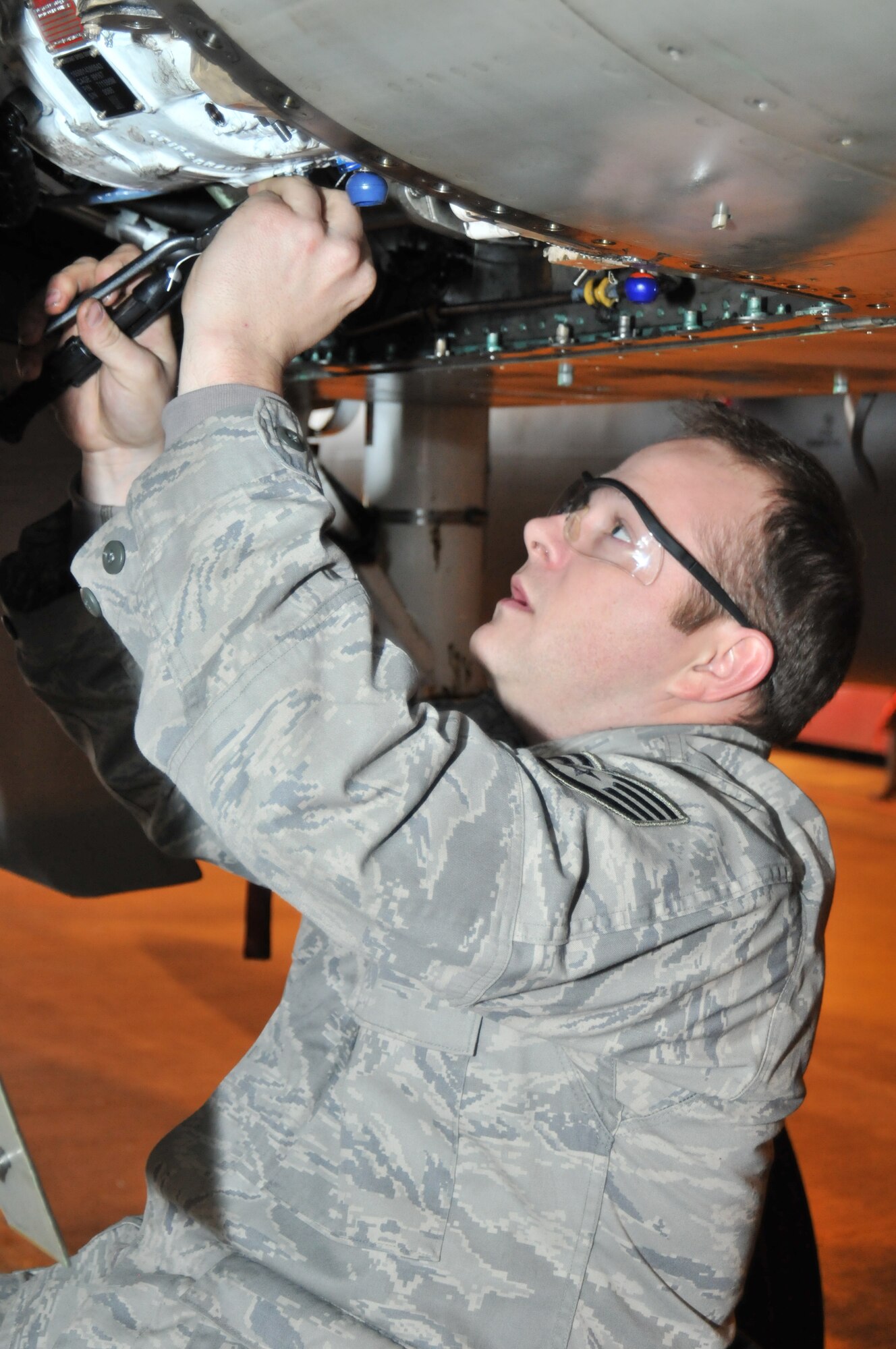 ROYAL AIR FORCE LAKENHEATH, England -- Staff Sgt. Joshua Howell, 493rd Aircraft Maintenance Unit electrical/environmental systems journeyman, installs safety wire on the drain plug for a new generator on an F-15 Nov. 23. Sergeant Howell was nominated for a Liberty Spotlight because he portrayed the core values ‘Integrity First’ and ‘Excellence in All We Do.’ (U.S. Air Force photo/Senior Airman David Dobrydney)