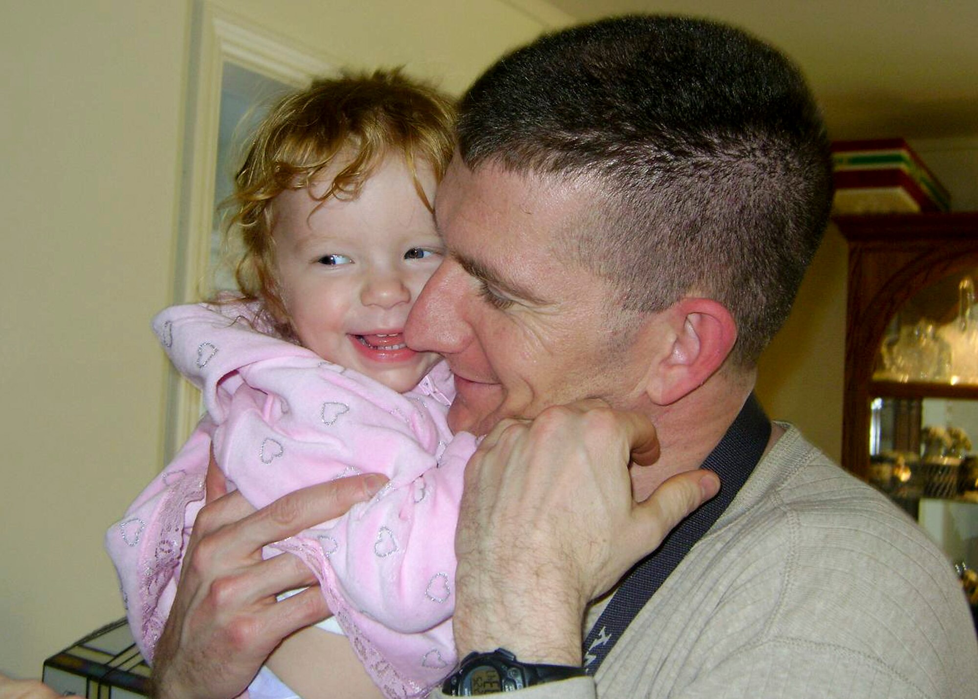 A then 1-year-old Amalia is all smiles as she is cuddled in her dad's arms during Christmas of 2008. Capt. Tony Cuciti was recently surprised with a pillowcase featuring a picture of Amalia on it through the Operation Pillowcase program. The free program, which ends Nov. 30, honors Military Family Month. (Courtesy photo.) 