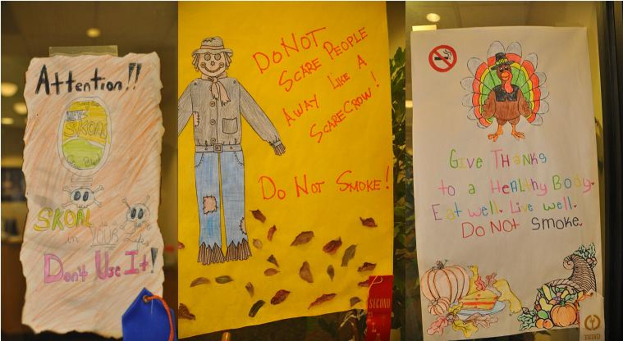 LAUGHLIN AIR FORCE BASE, Texas – The award-winning posters from the Great American Smokeout held here Nov. 18 are displayed in Laughlin’s Health and Wellness Center lobby. In order from left to right, first place was awarded to Kayla Herzog, second place was given to Macy Oyala and third place to Maui Oyala.  (U.S. Air Force photo by 2nd Lt. Ashley Wolfe)